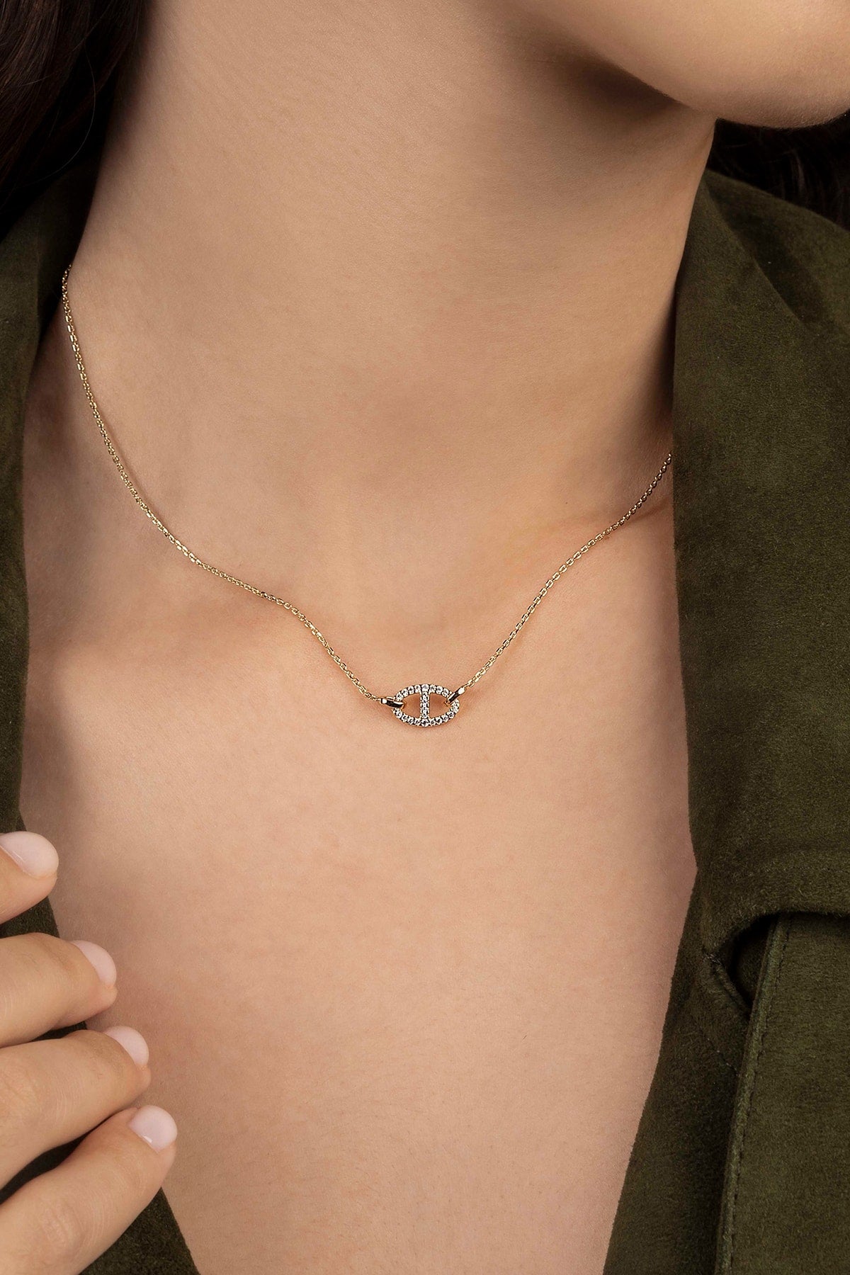 Necklace with a small pendant worn by a person