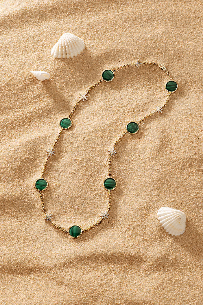 Necklaces APM Monaco choker with a gold chain, malachite stones, and pave diamonds.