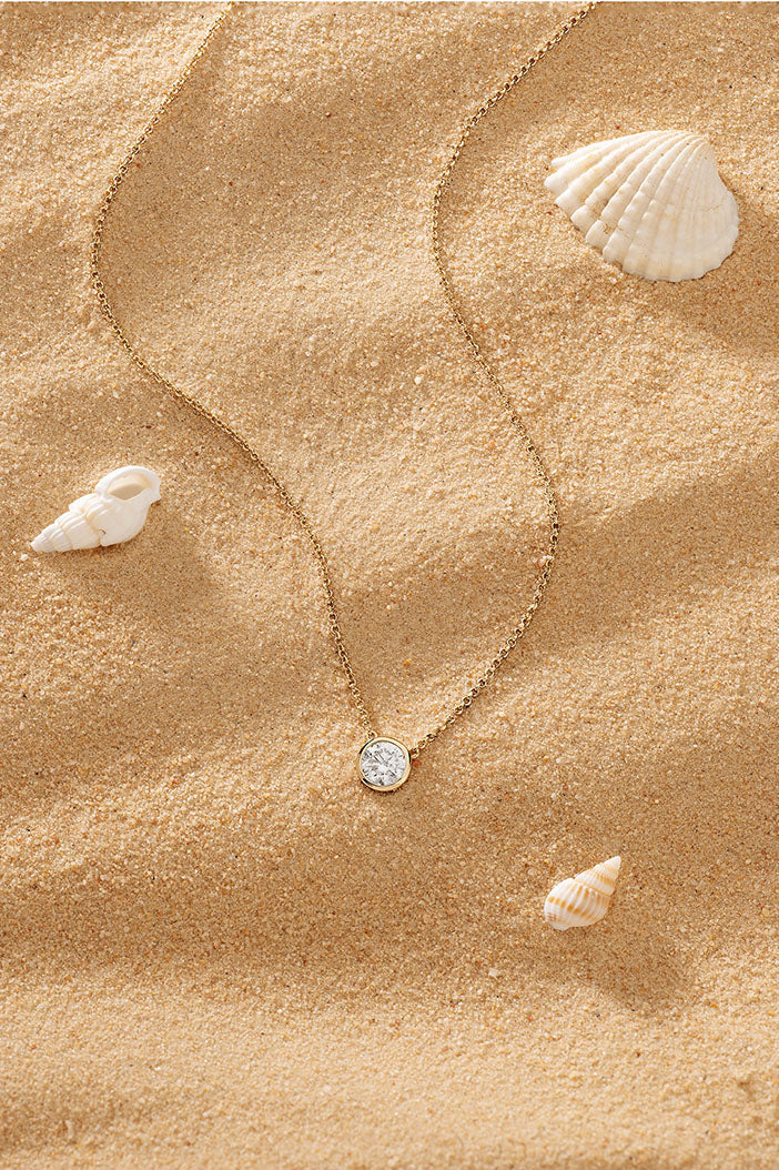 Necklaces APM Monaco, yellow gold adjustable chain with white diamond pendant.