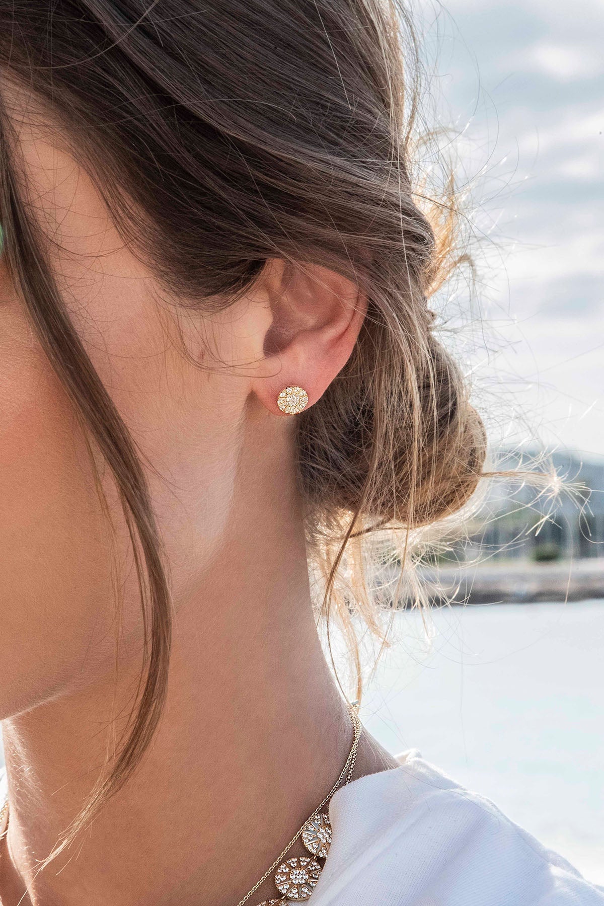 Earrings APM Monaco, yellow gold-toned stud earring with a simple round shape.
