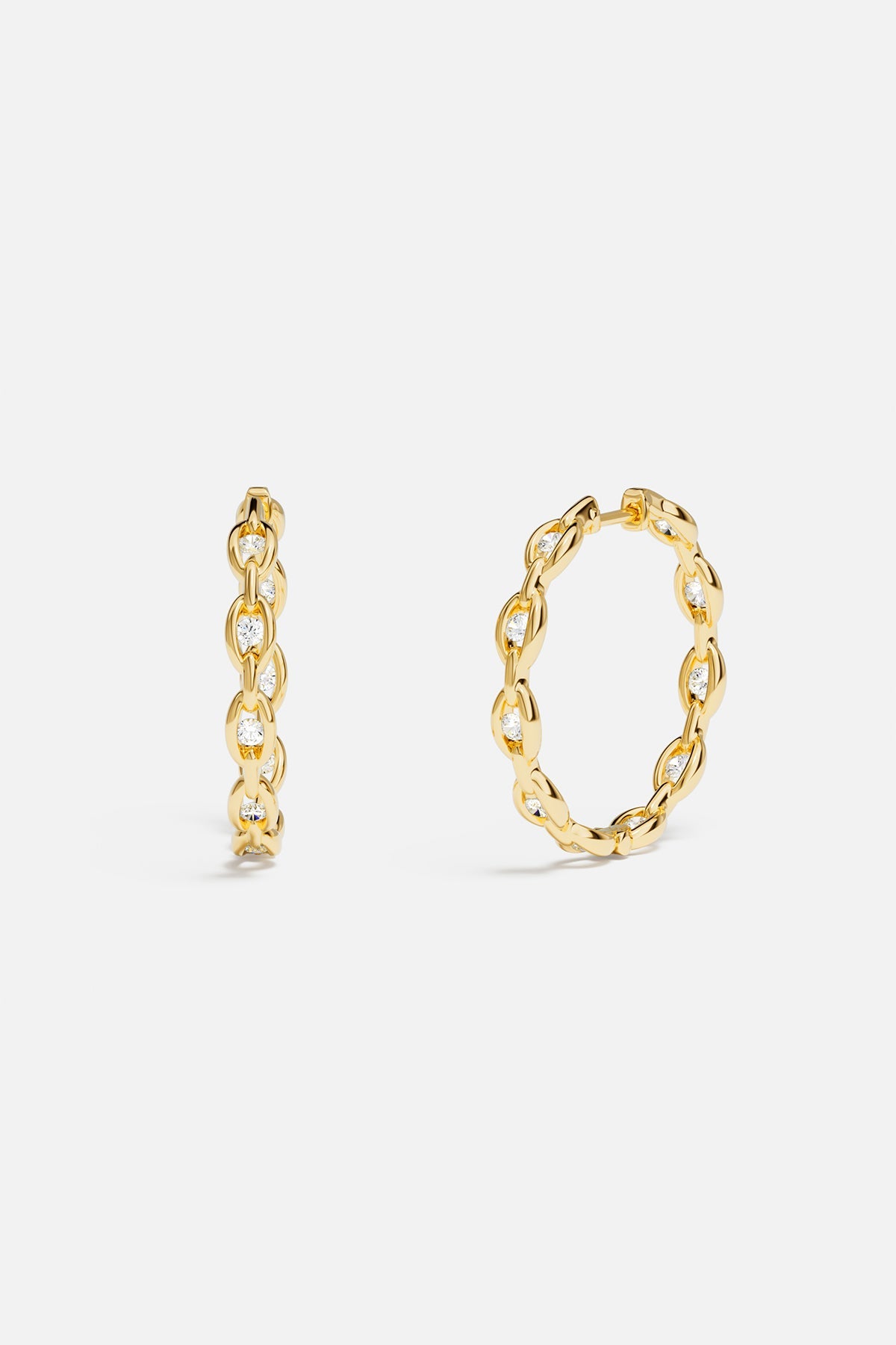 Earrings APM Monaco: yellow-gold pavé chain hoops with white diamonds.
