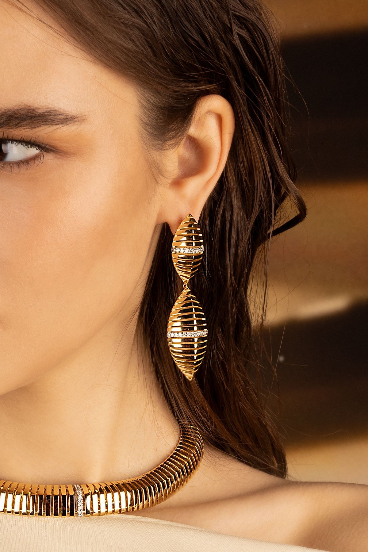 Earrings, APM Monaco — yellow gold statement sunray design with diamond accents.