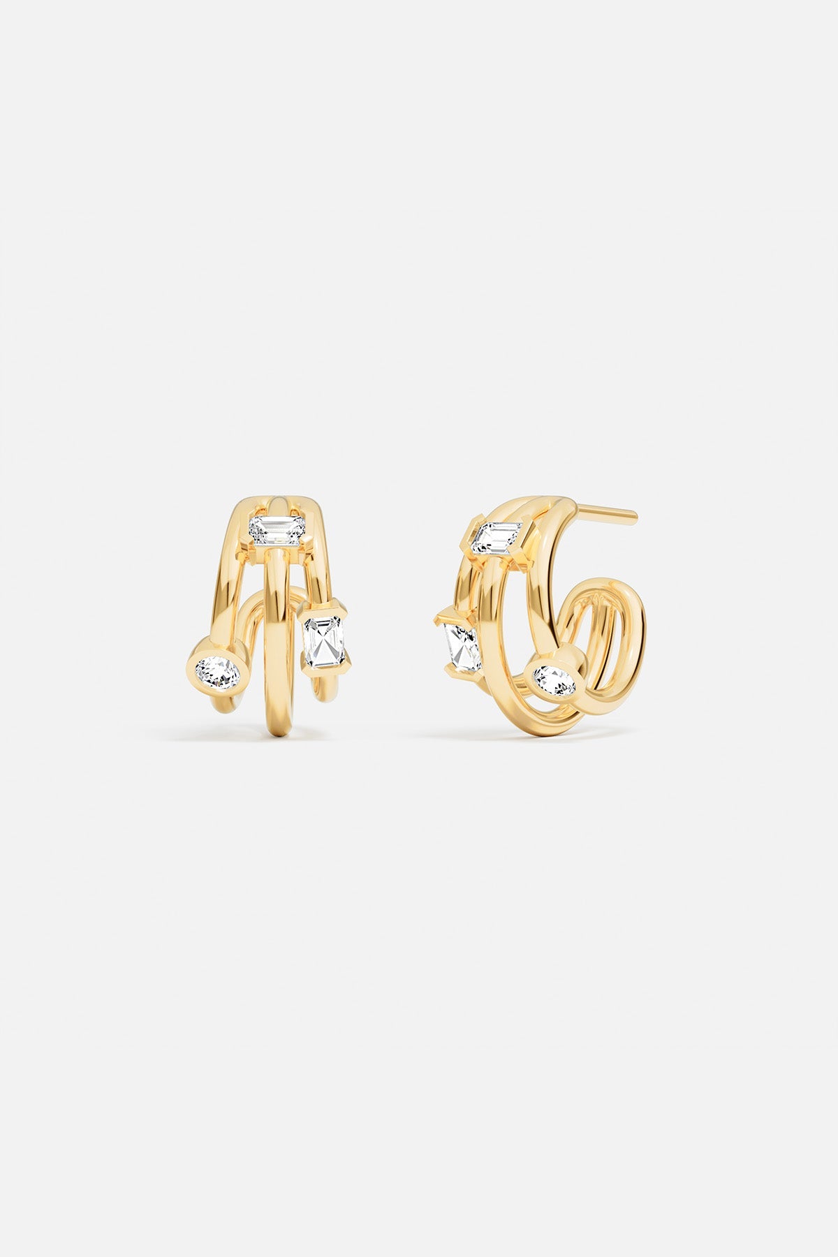 Earrings, APM Monaco: gold-tone pair with two vertical hoops and two small white gems.