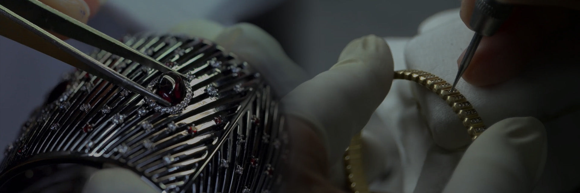 Close-up of hands working on a piece of jewelry with intricate designs.
