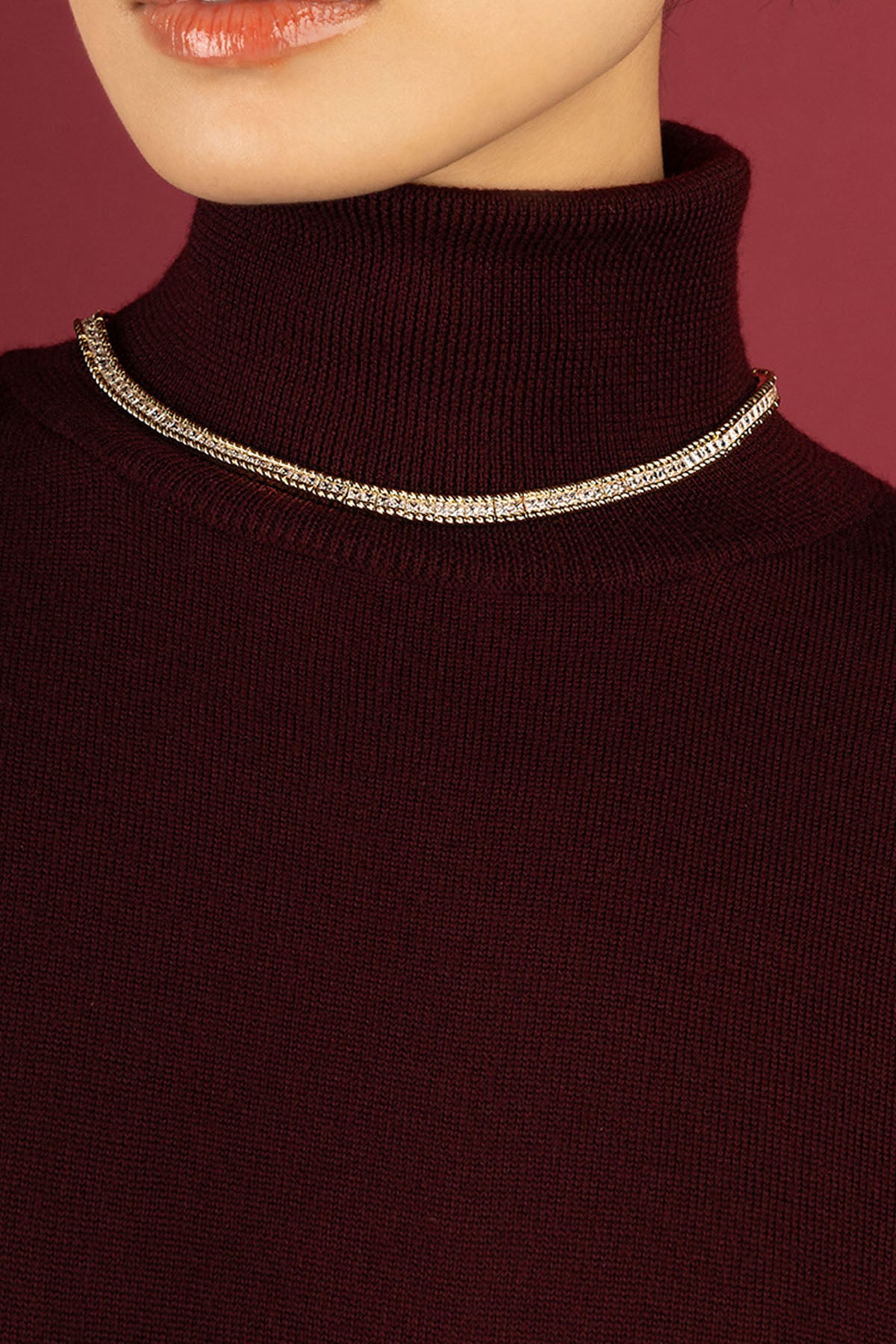 Woman wearing APM Monaco necklace, a shimmering line of quiet elegance.