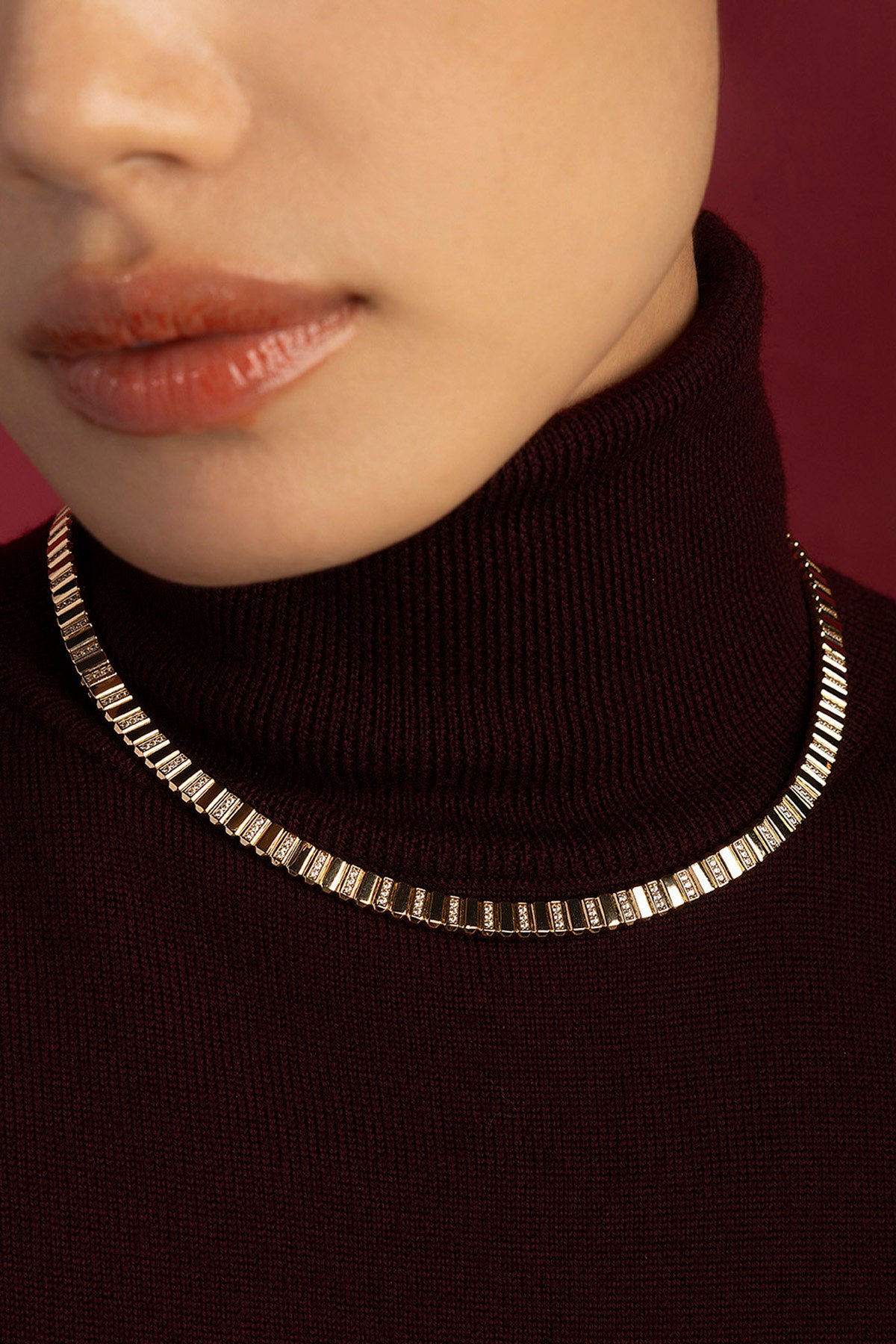 Woman wearing APM Morse Necklace, a golden whisper of modern elegance.