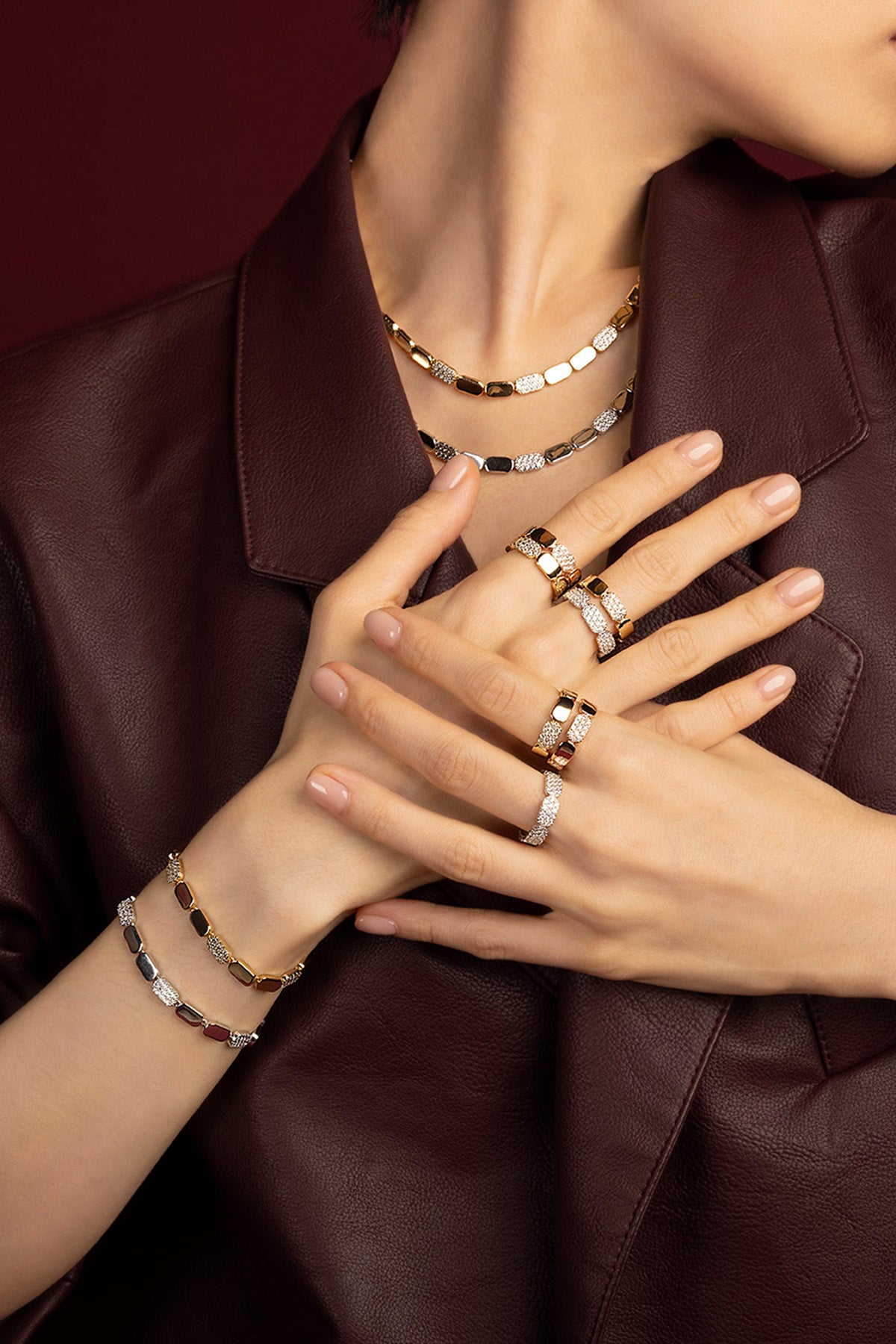 Woman wearing APM Morse jewelry set, a bold rhythm of golden light and quiet sparkle.