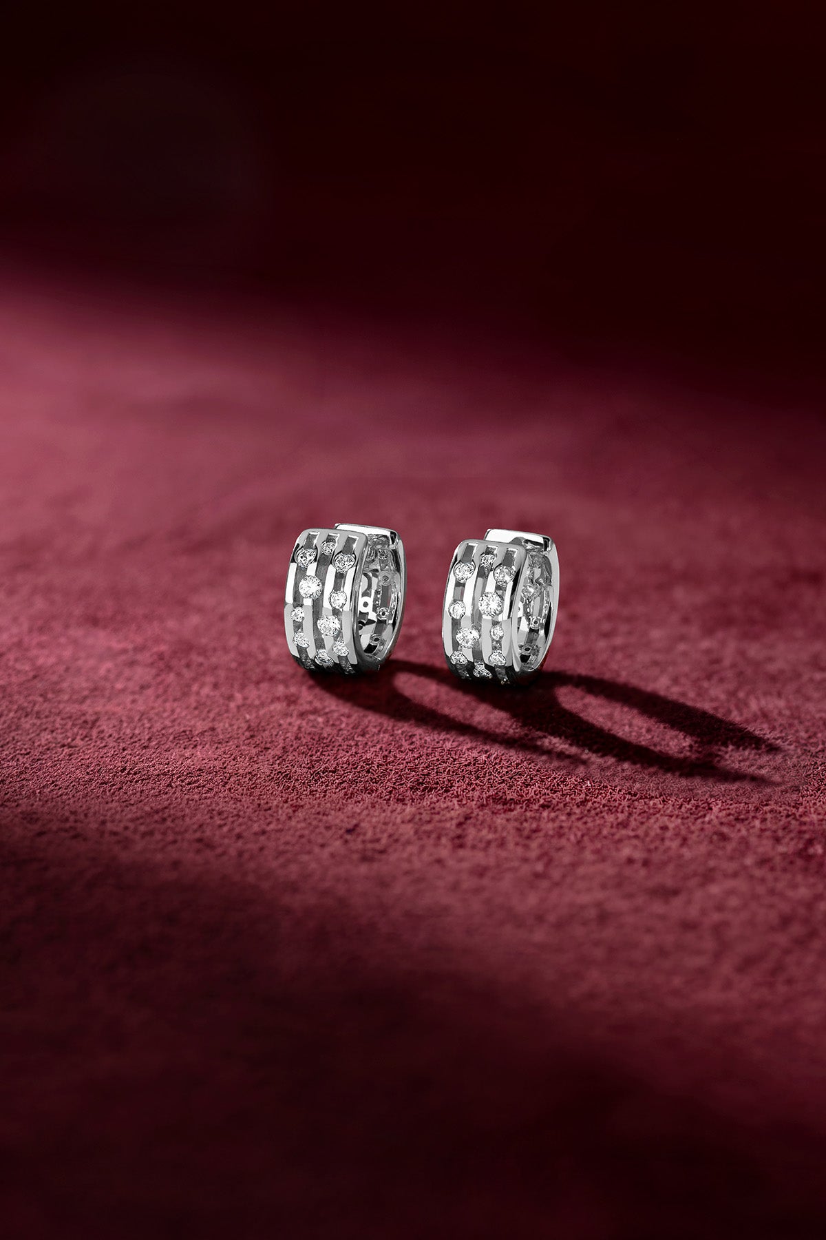 APM Hoop Earrings glimmer softly on velvet, a whisper of modern elegance.