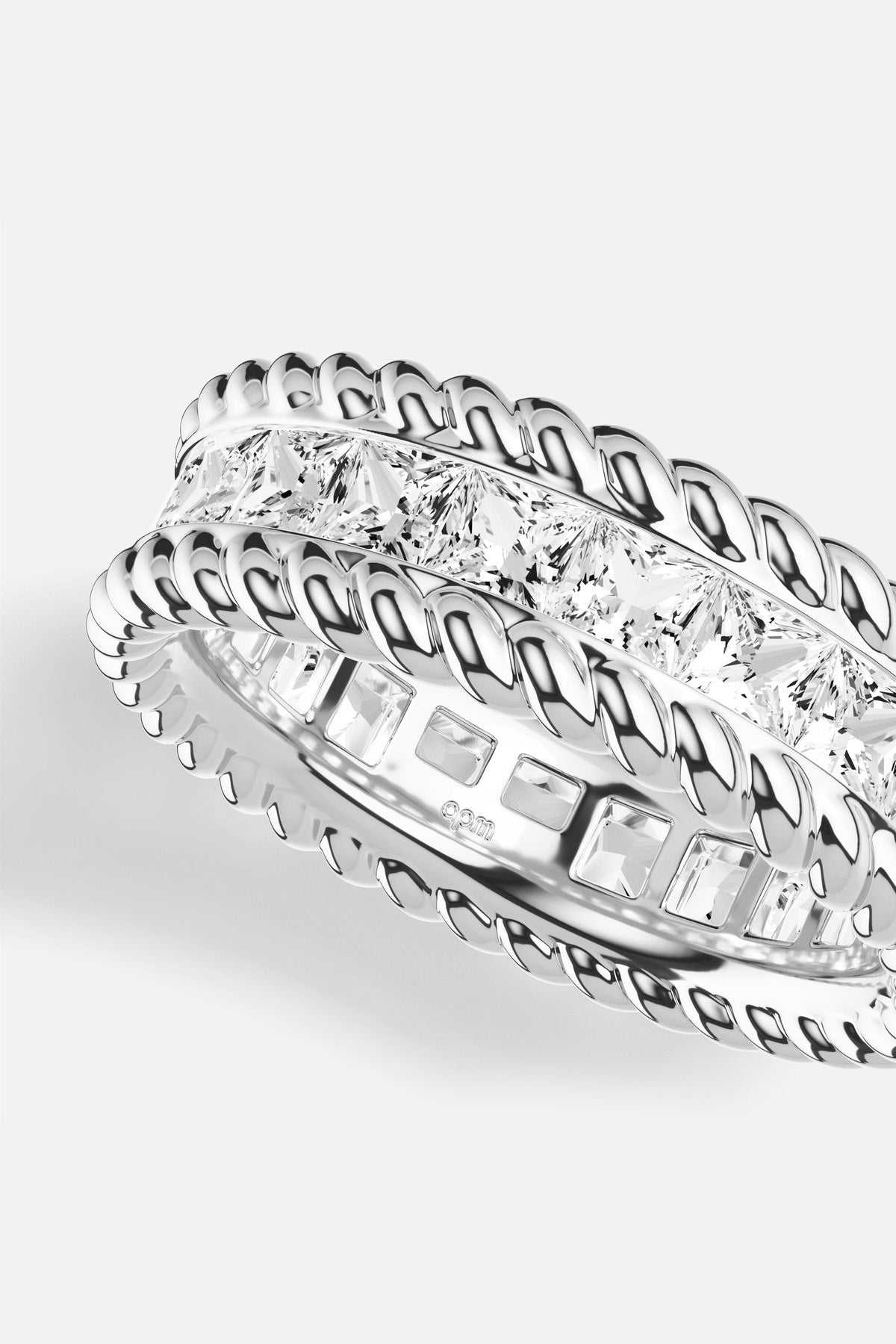 APM Ring, twisted rhodium finish framing a luminous line of crystals, effortlessly radiant.
