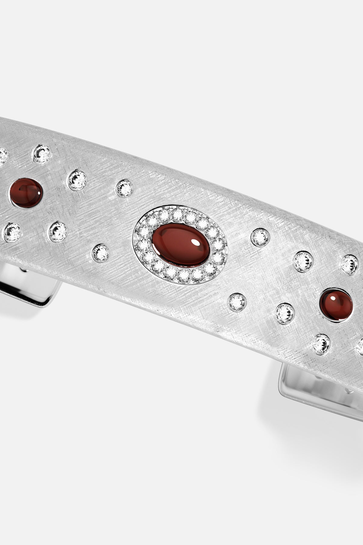 APM Bracelet in rhodium finish, deep red stones glowing amid a starlit shimmer.