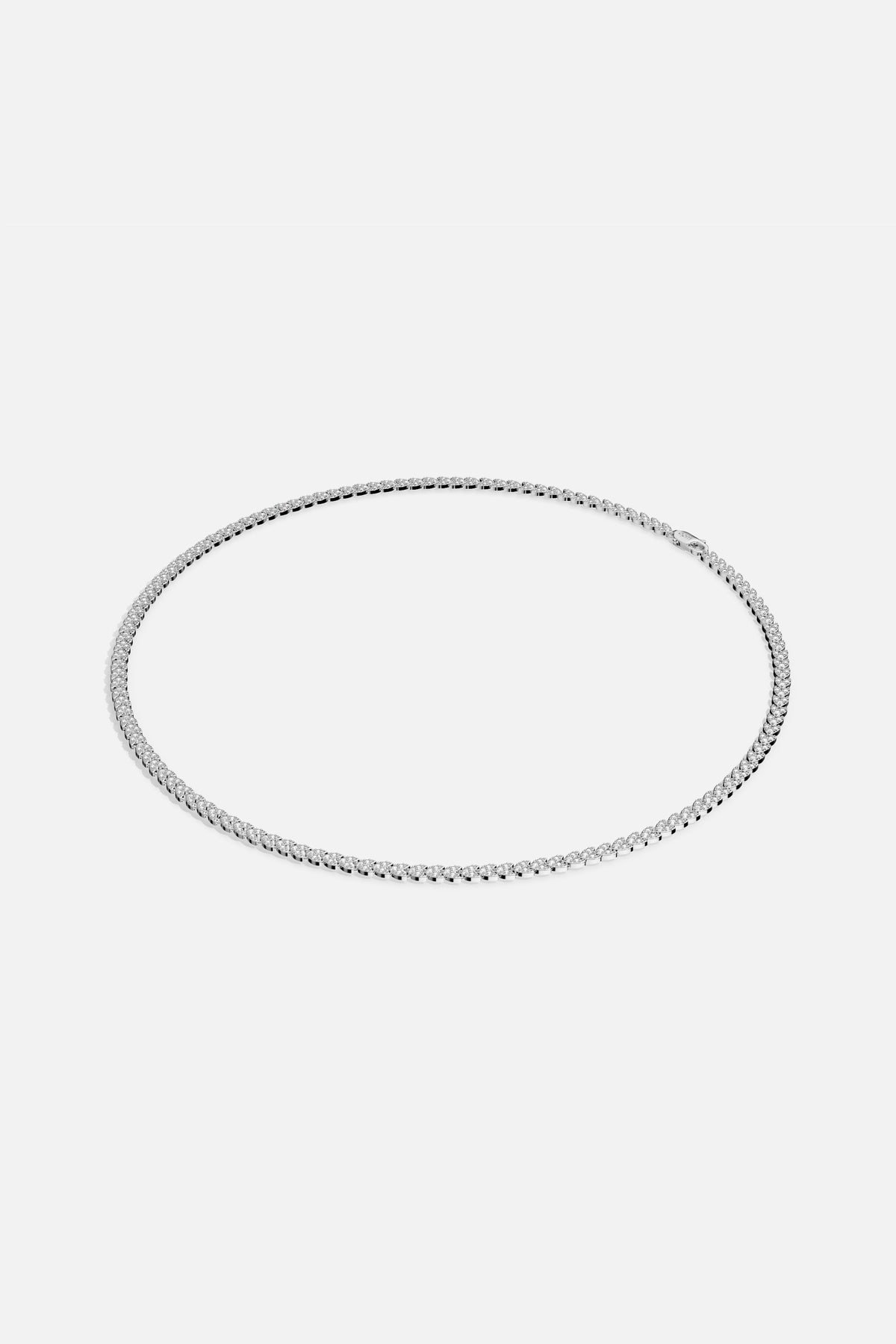 APM Tennis Necklace, a timeless line of light encircling every look with quiet brilliance.