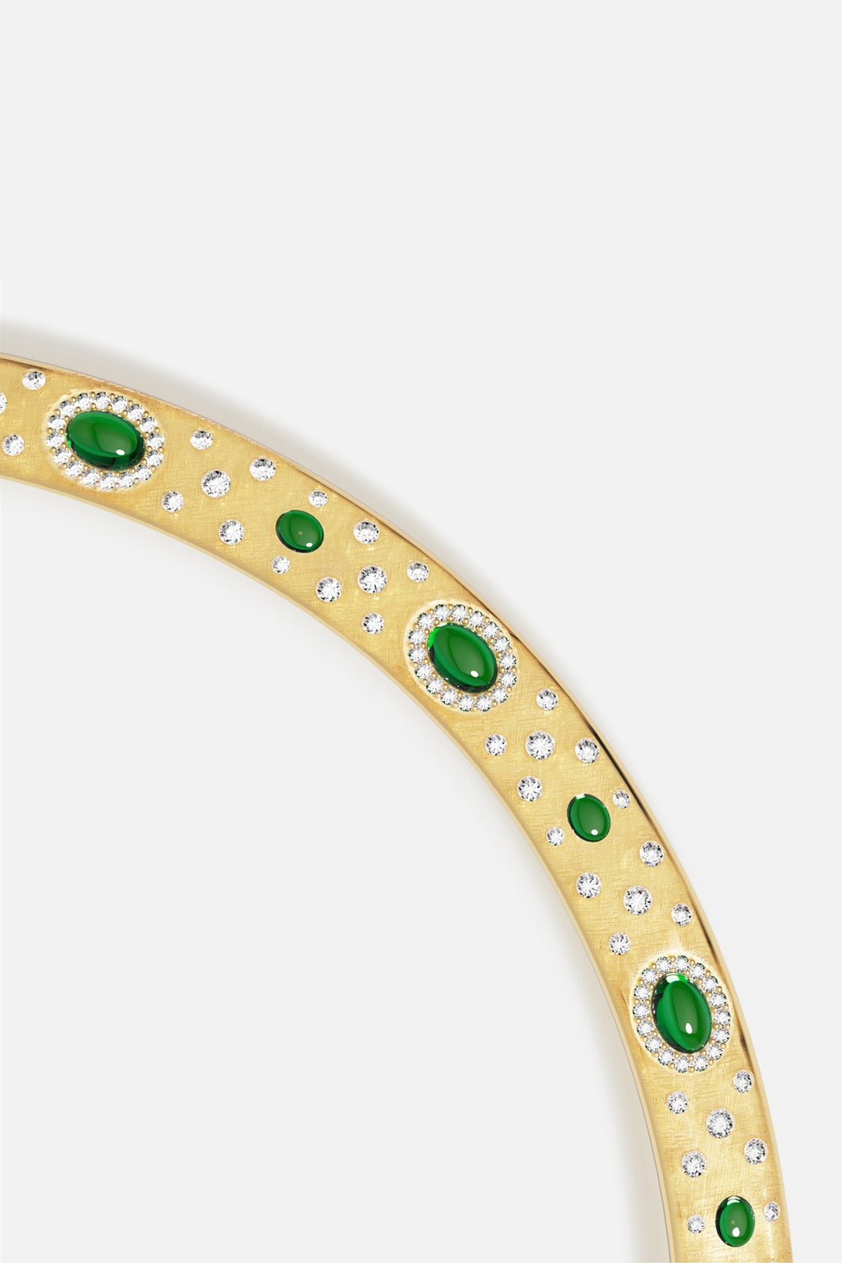 APM Bangle in golden hues, scattered with green stones and shimmering sparkle.