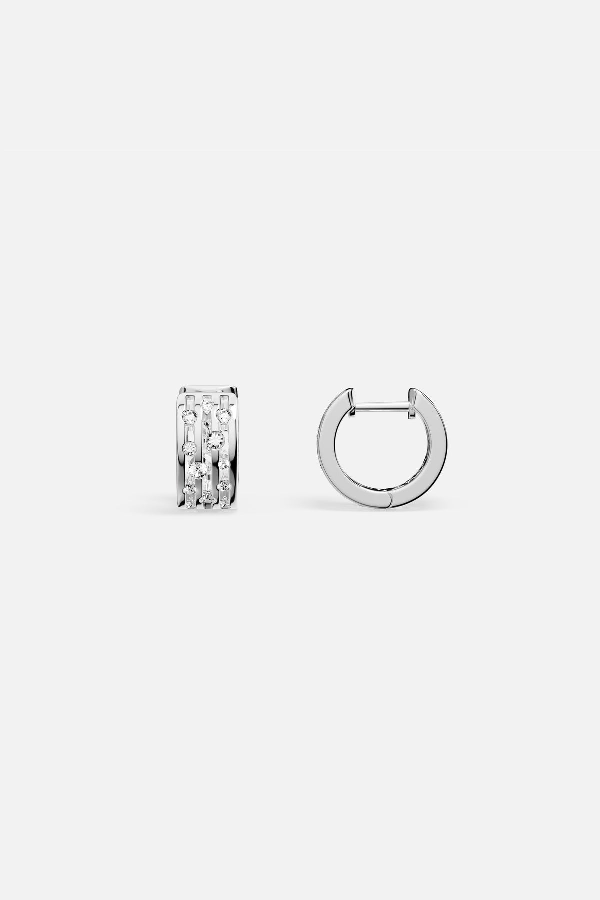APM Hoop Earrings in rhodium finish, a sparkling whisper of modern elegance.