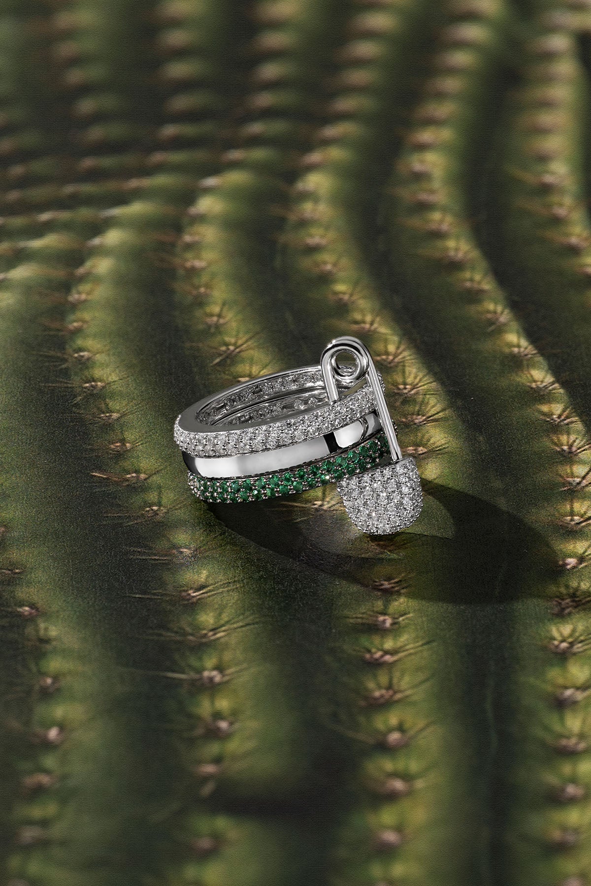 Silver ring with green stone on a cactus background