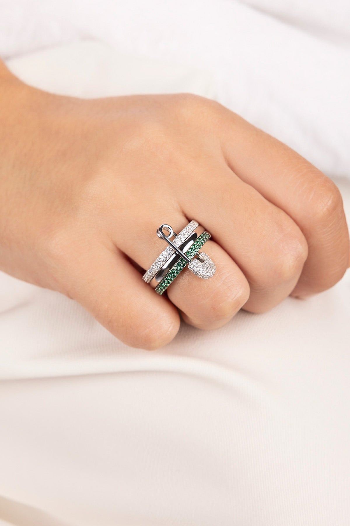 Close-up of a hand wearing a ring on a white background