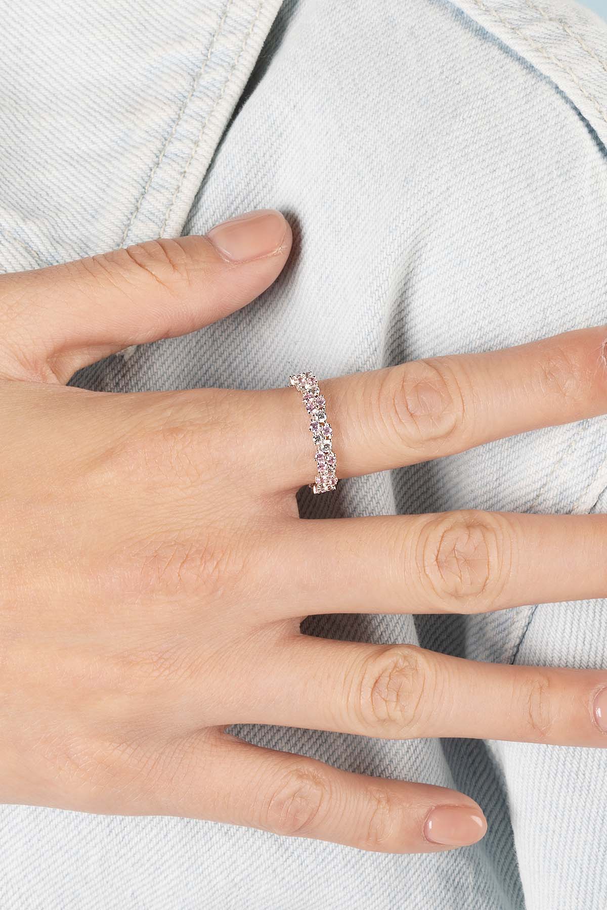 Rings APM Monaco rose drop pink diamond ring worn on a finger.