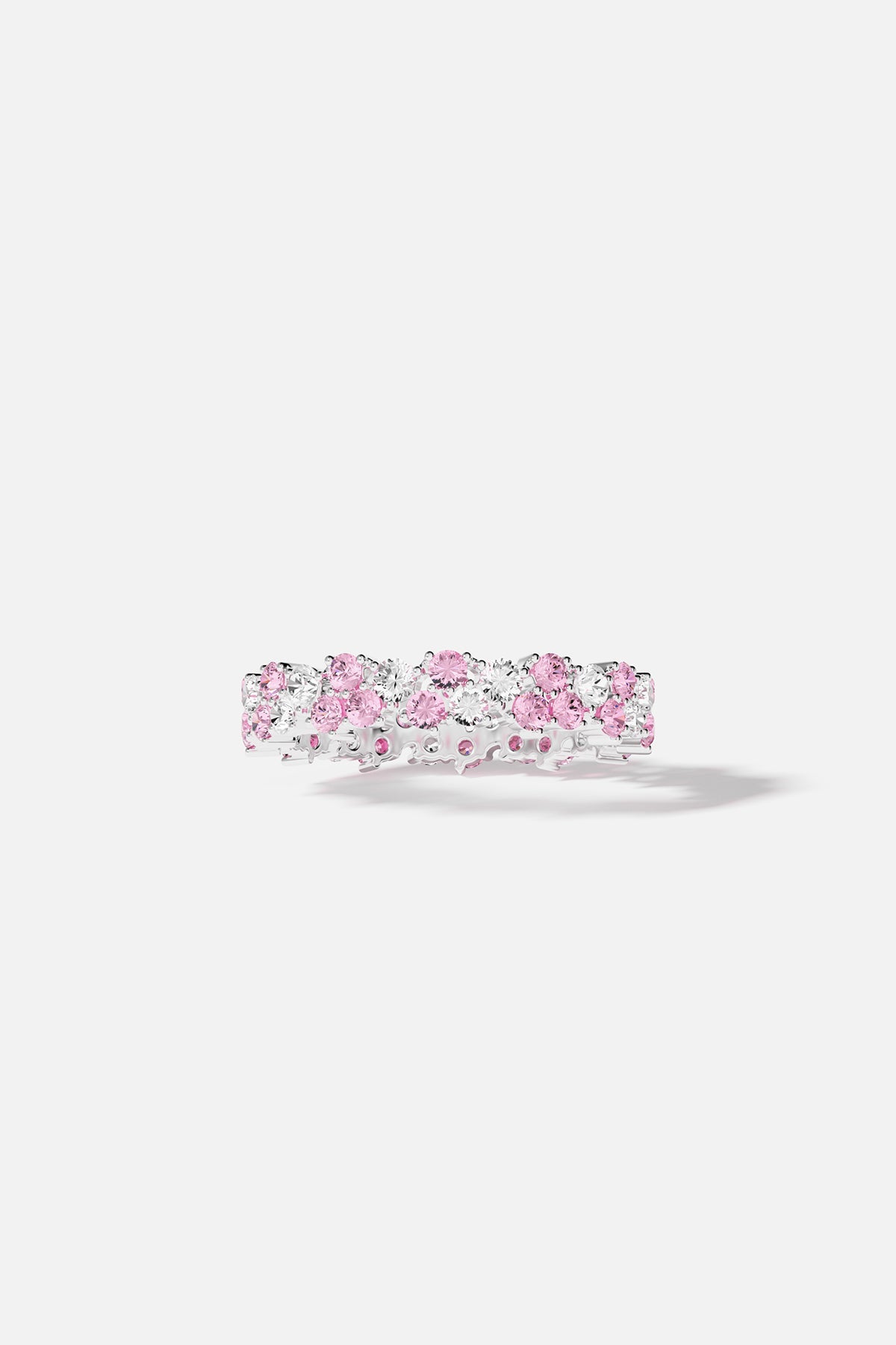 Rings APM Monaco. White color tone with pink and white gemstones set on a silver band.