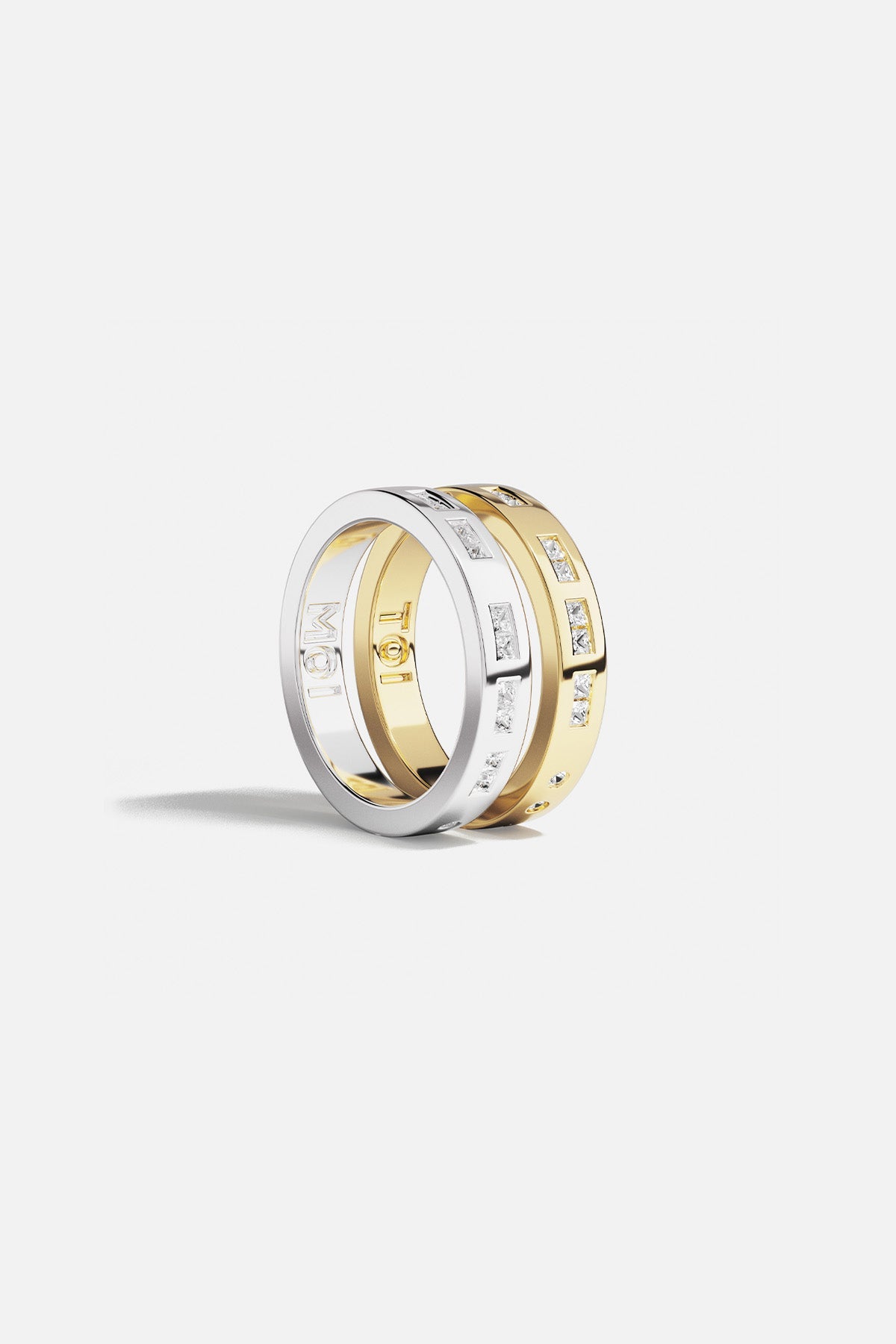 Rings APM Monaco: two stacked rings, yellow gold and white gold, pavé diamonds, one with MOI engraving.