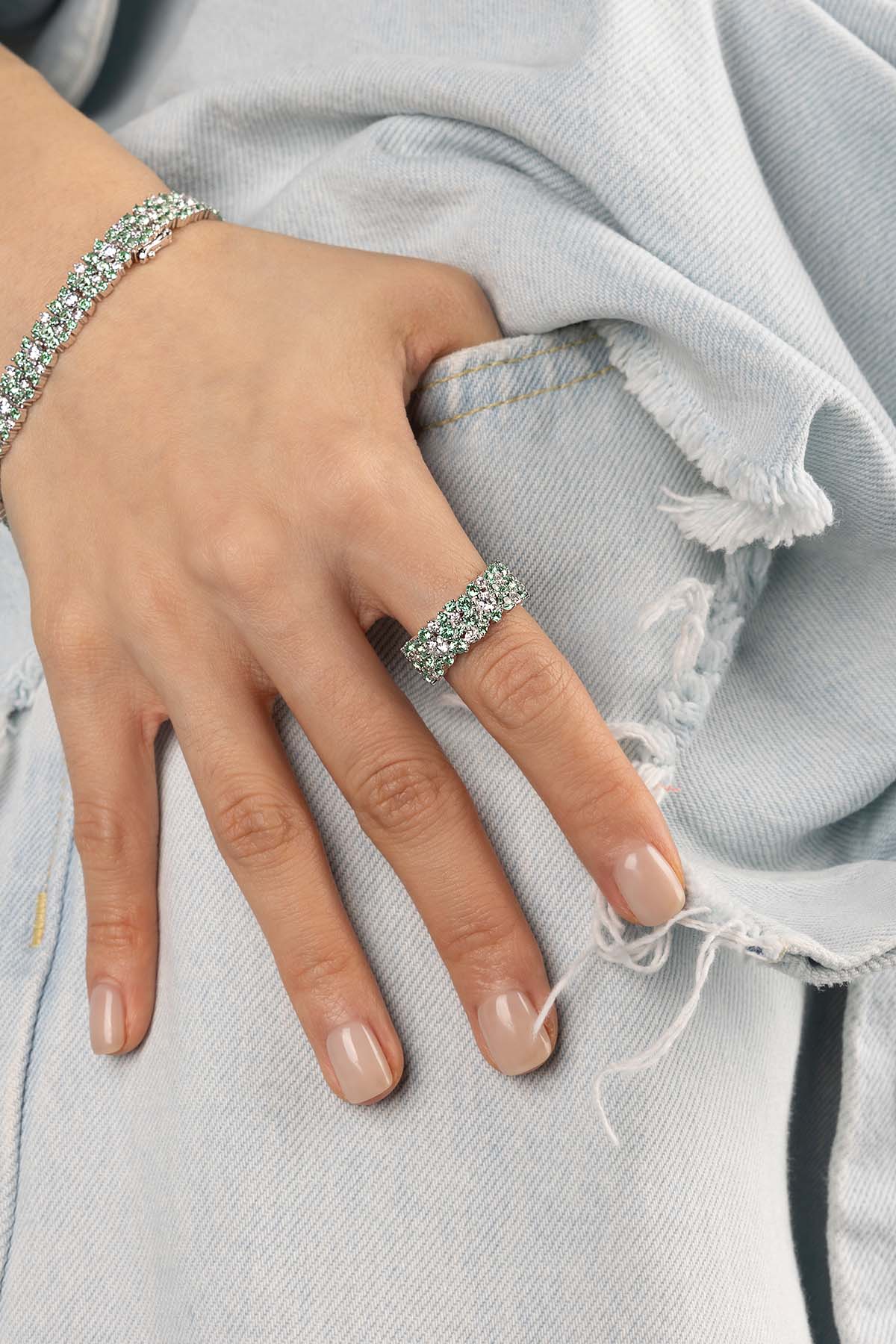 Rings APM Monaco, pastel-green drop ring with a delicate drop gemstone on a slim metal band.