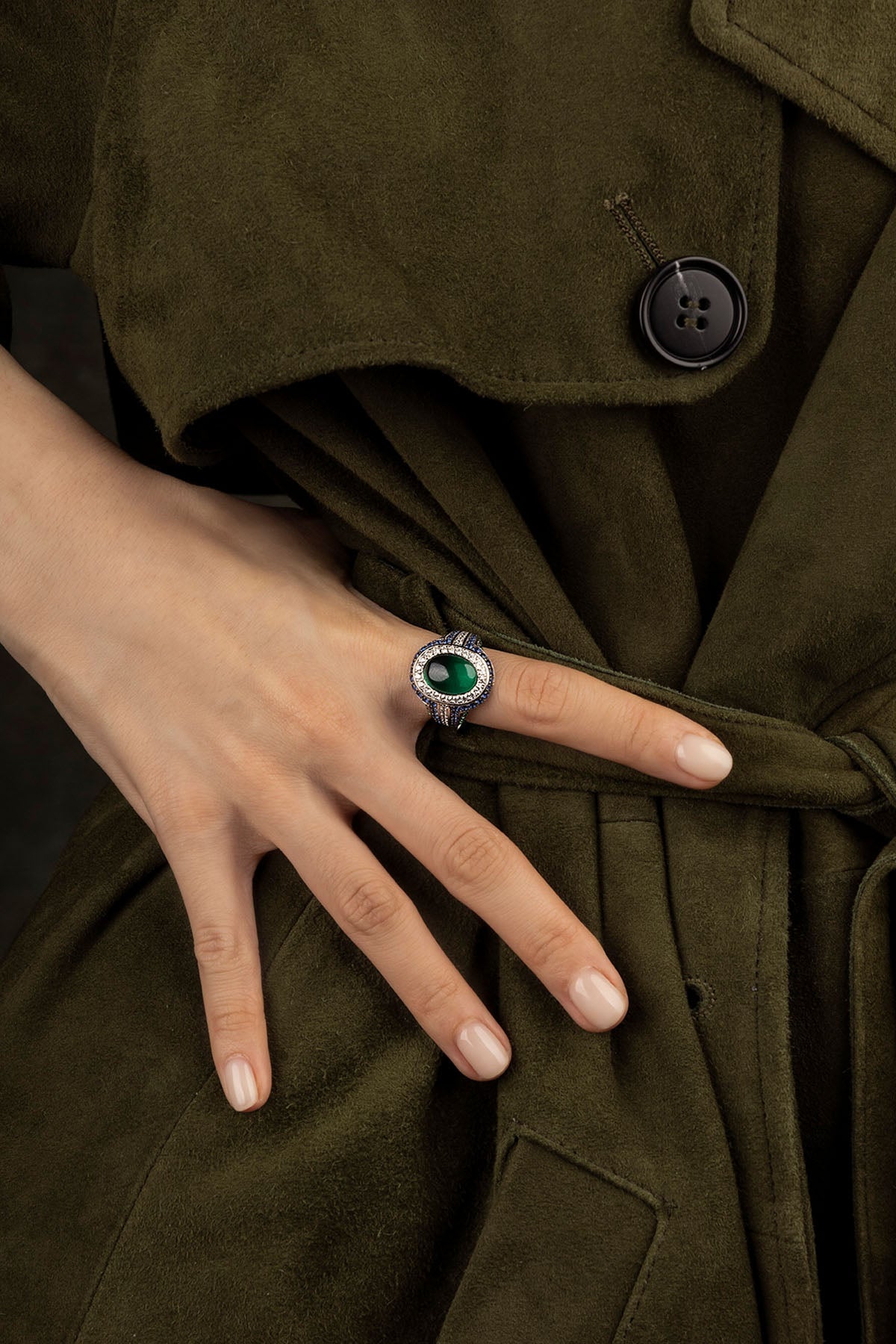 Hand wearing a APM Monaco Bold Green and Blue Ring in silver