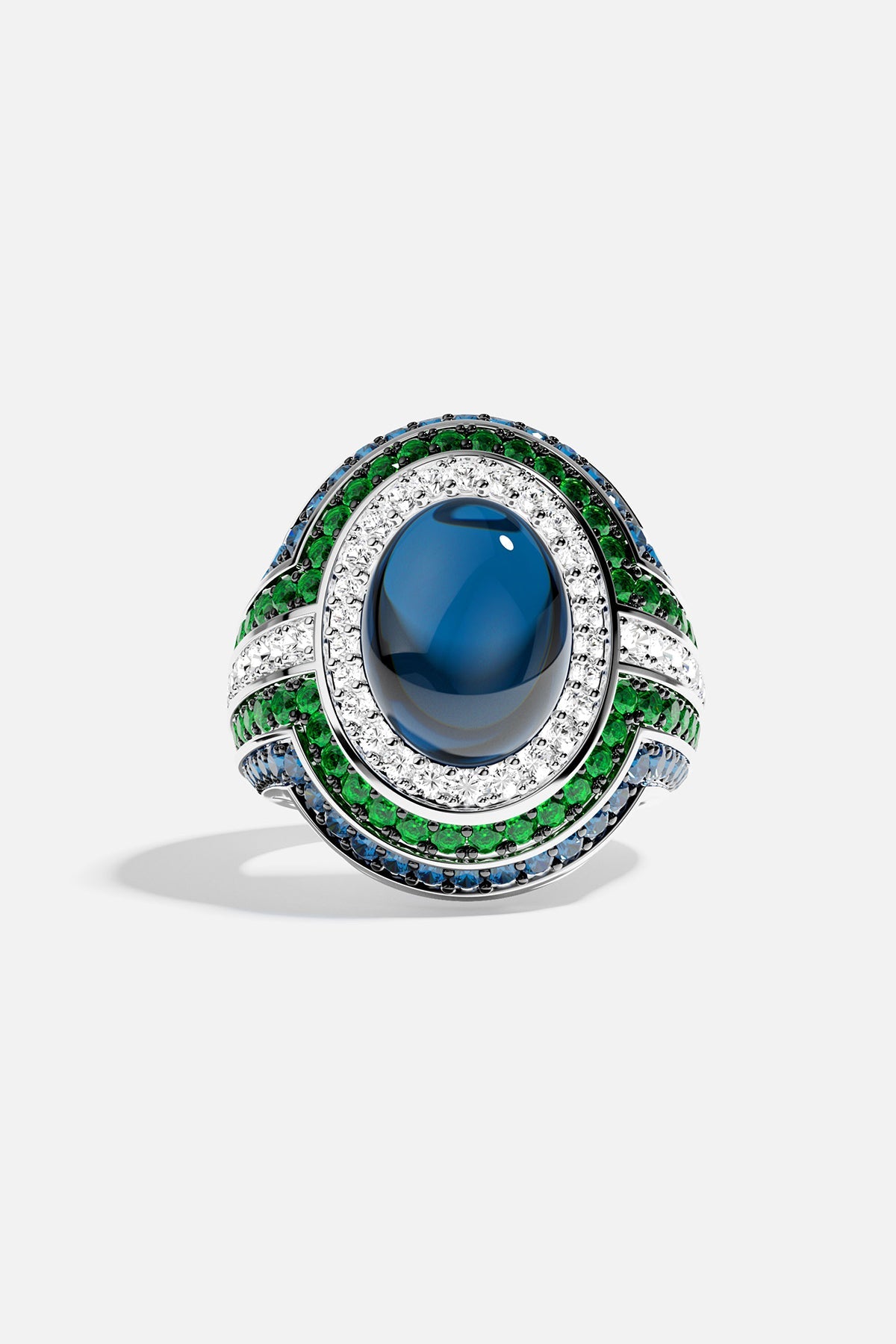 Ring with a green stones and blue accents on a white background