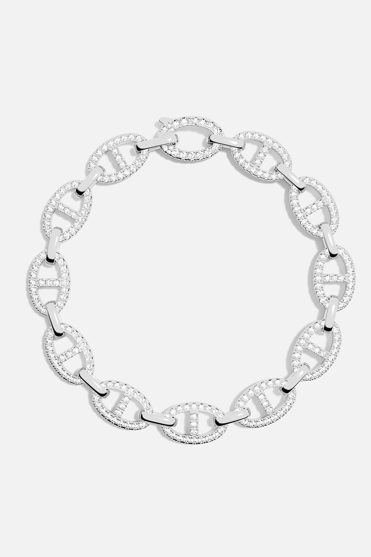 Bracelets APM Monaco: silver chain bracelet with interconnected oval links, pavé crystals in each link, and a distinctive H-shaped detailing within the oval frame.