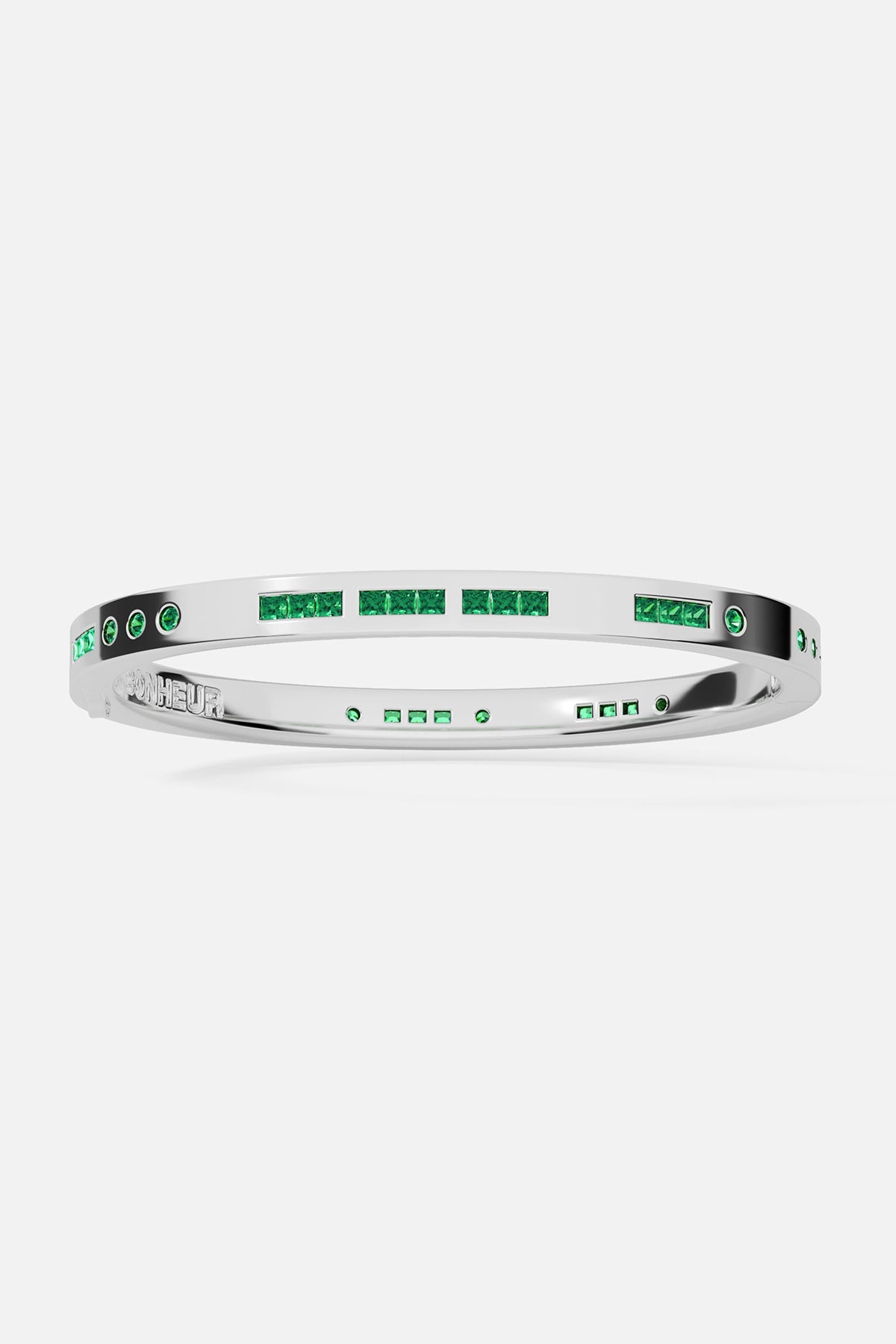 Silver bracelet with green stones on a white background