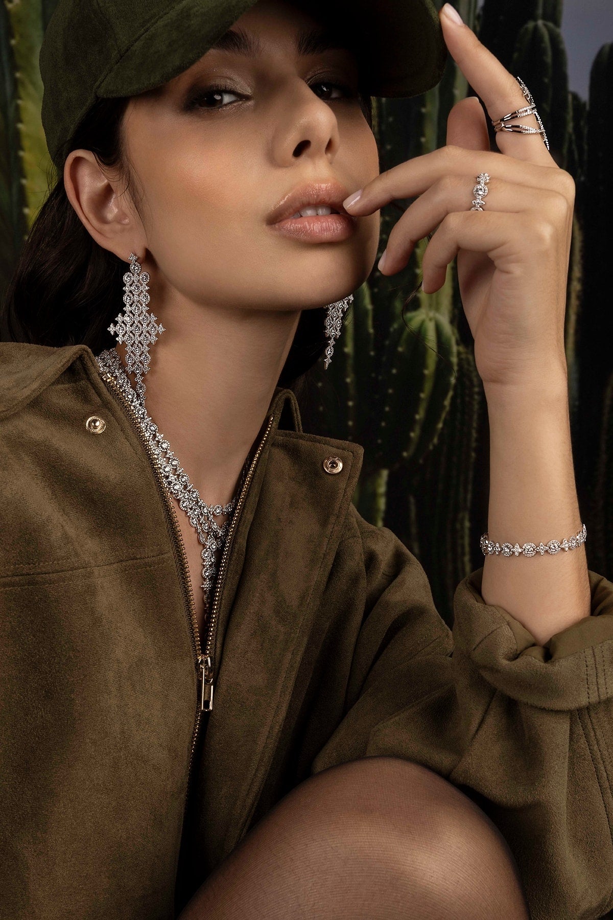 Woman wearing jewelry with a cactus background