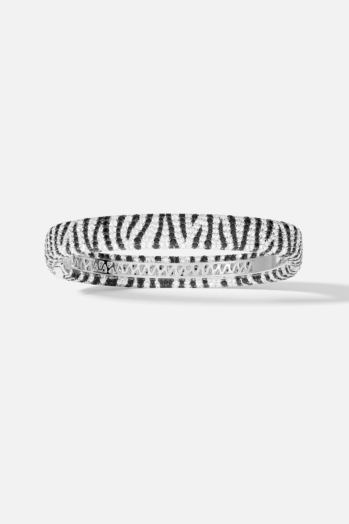 Bracelets APM Monaco: a silver-tone zebra-print bangle with alternating black and white stones.