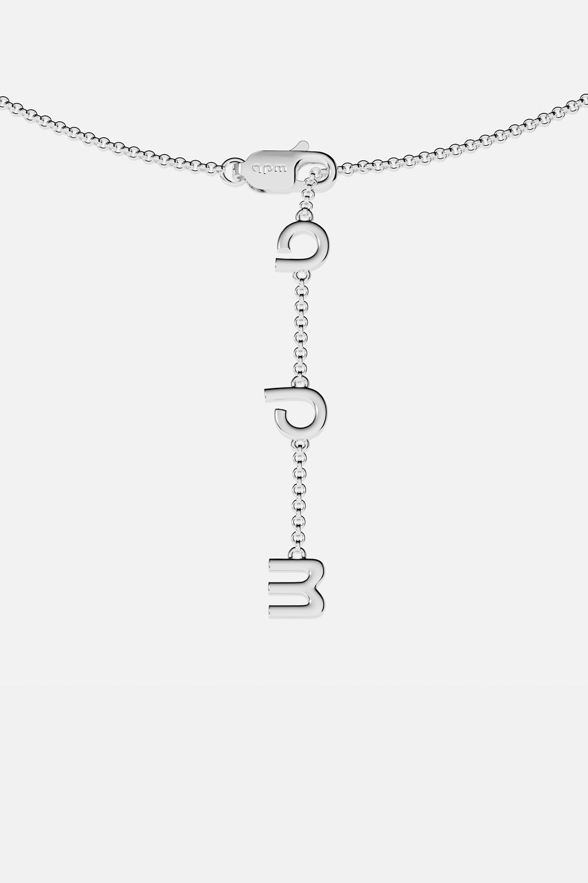 Silver necklace with hanging letter pendants on a white background