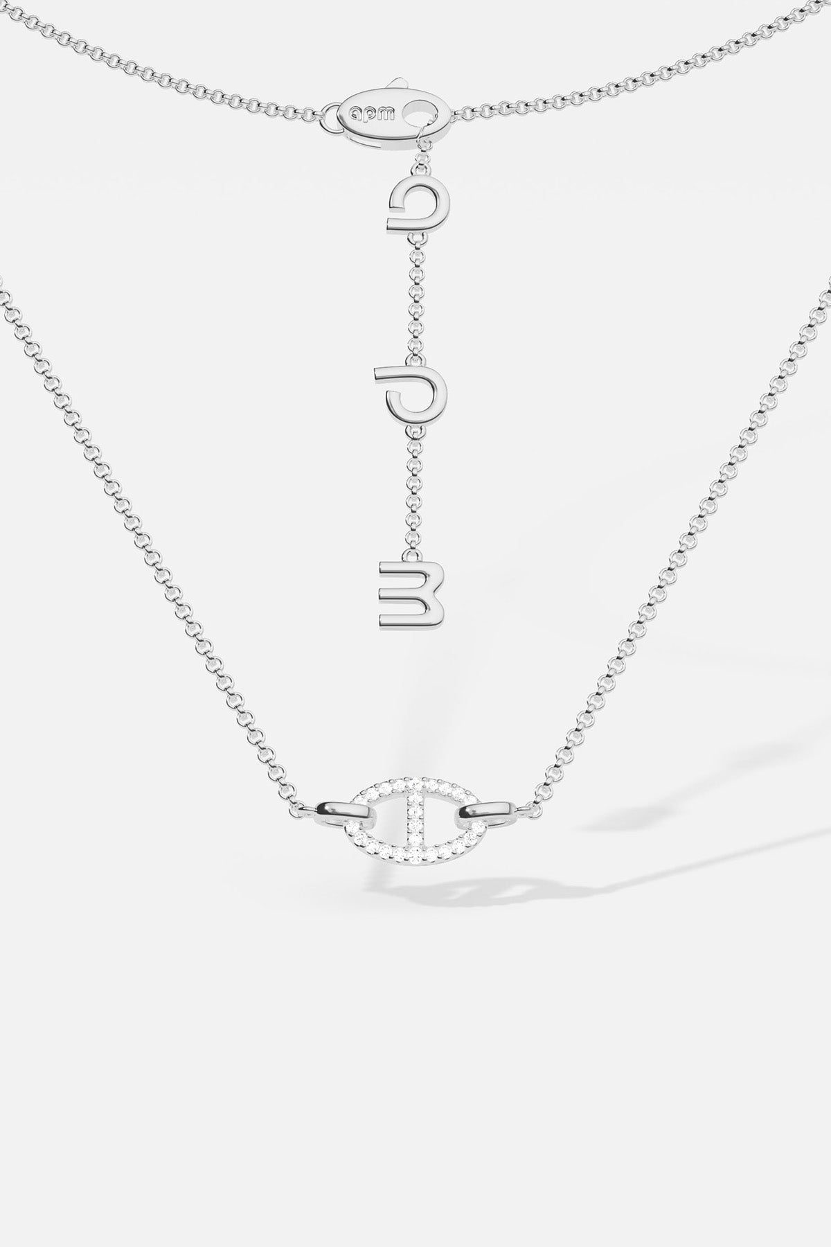 Necklaces APM Monaco, white tone, maille marine chain with a pendant of three hanging letters.