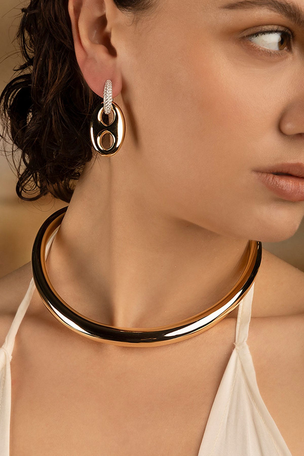 Necklaces APM Monaco and Earrings APM Monaco: yellow gold-tone choker with matching earrings.