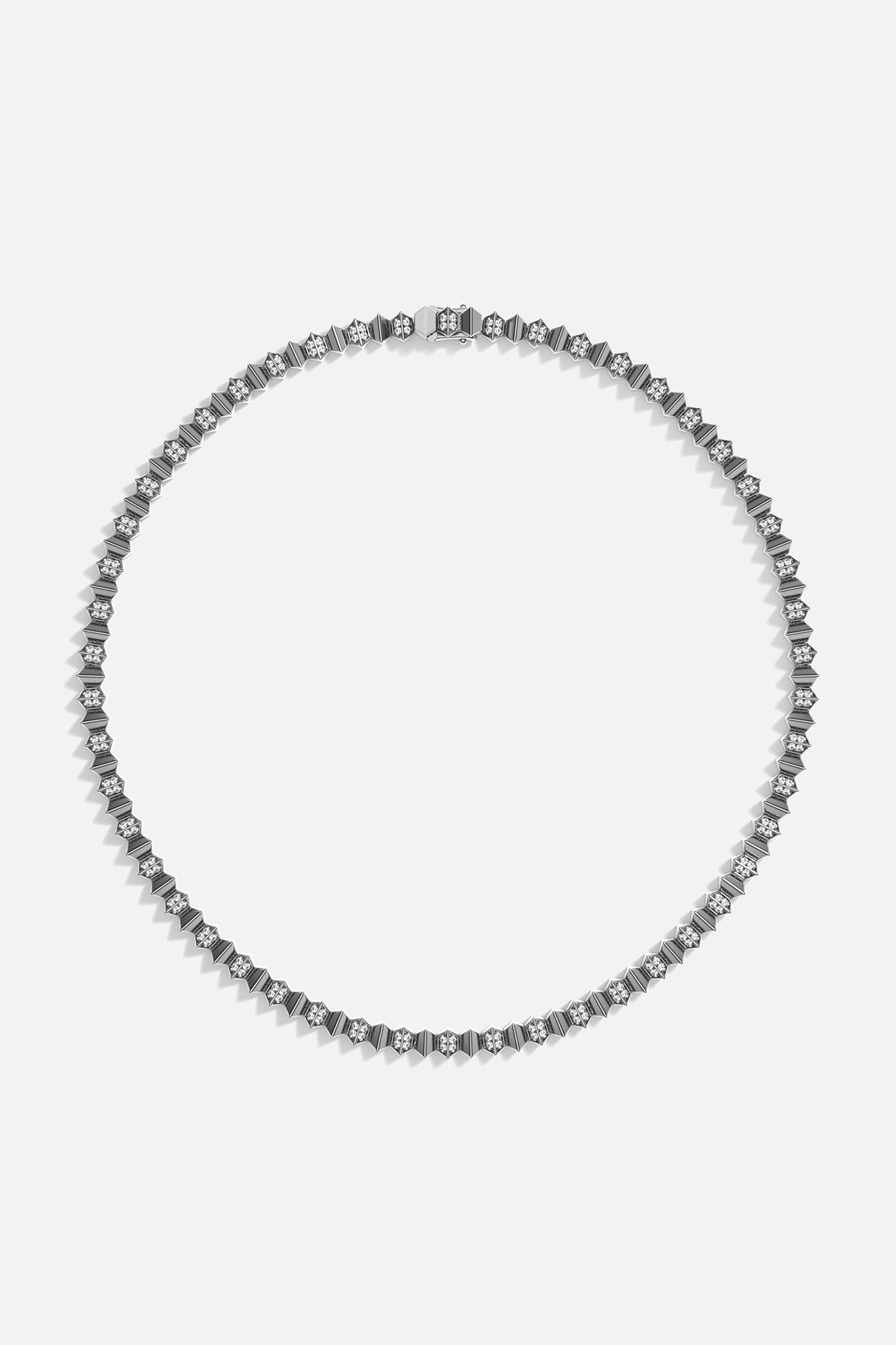 Silver necklace on a light gray background