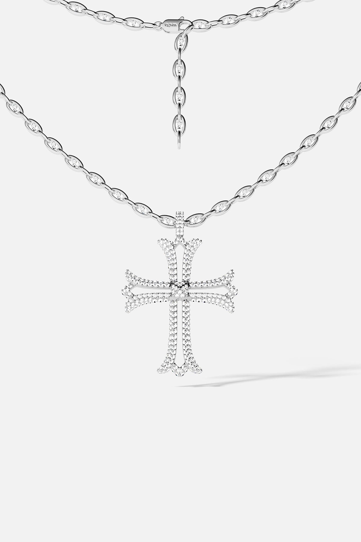 Silver cross necklace on a white background