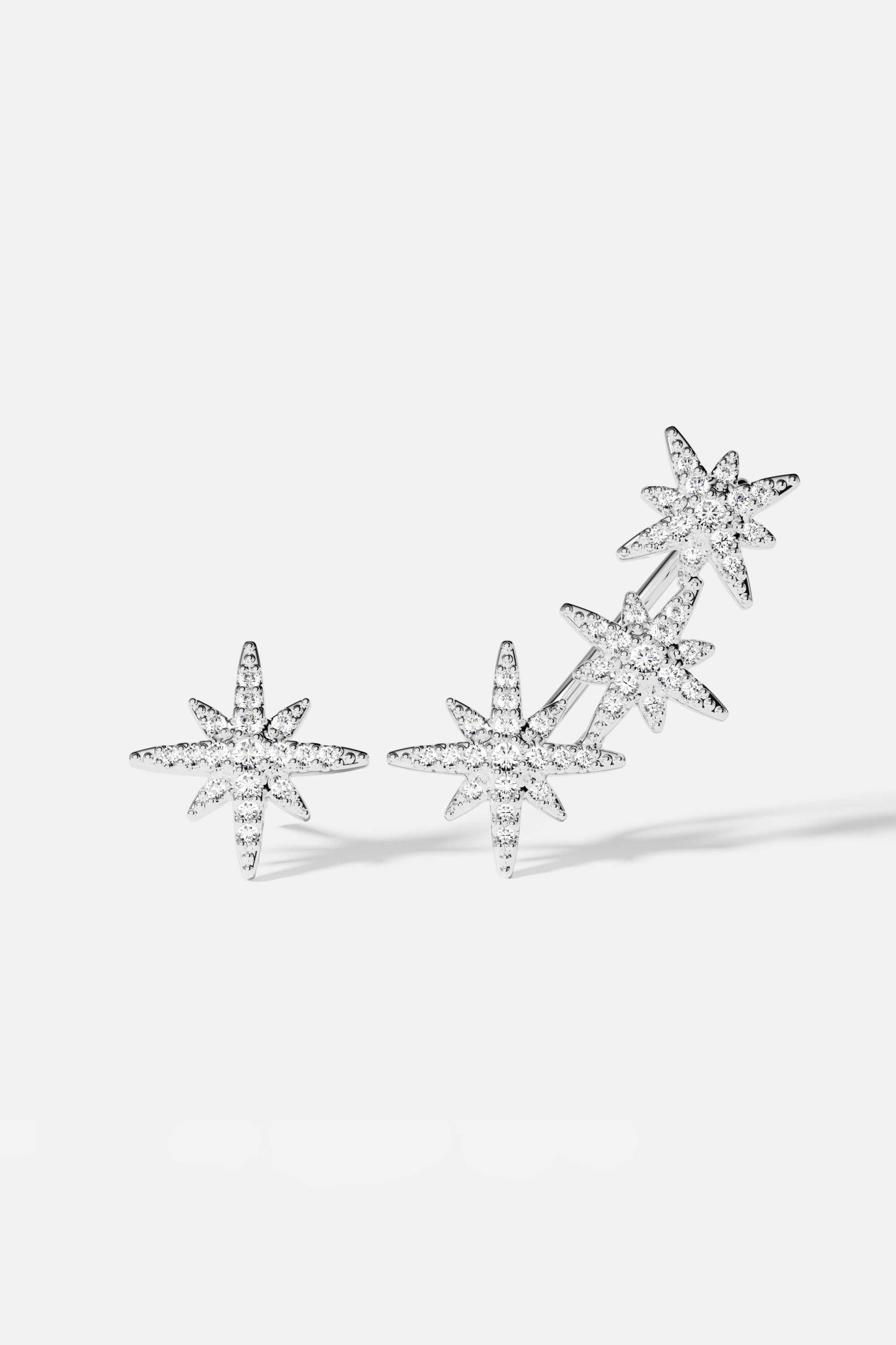 Earrings APM Monaco, silver-tone asymmetric triple meteorite crystal earrings.
