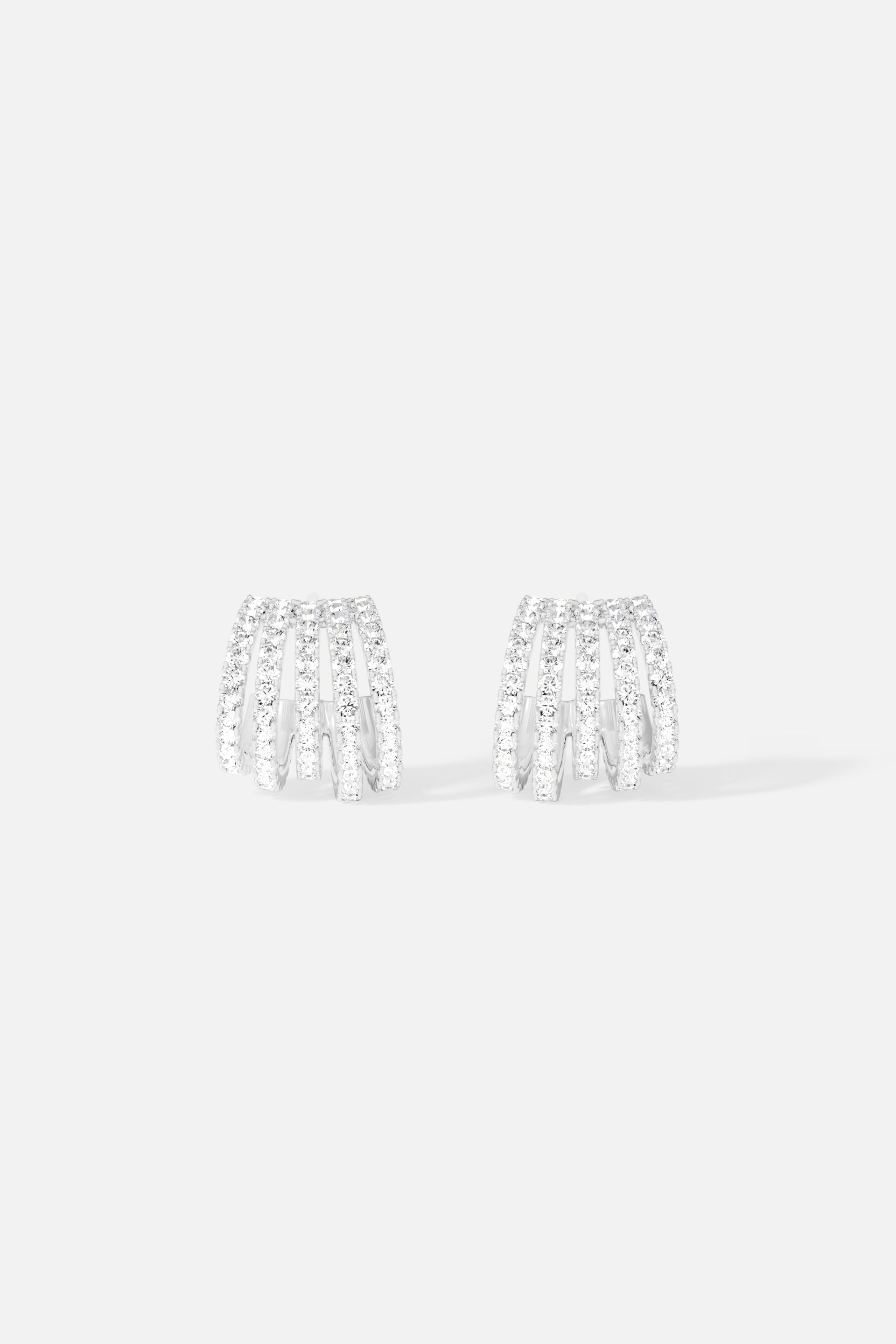 Earrings APM Monaco: five-hoop silver pavé-set crystal earrings with stacked hoops.