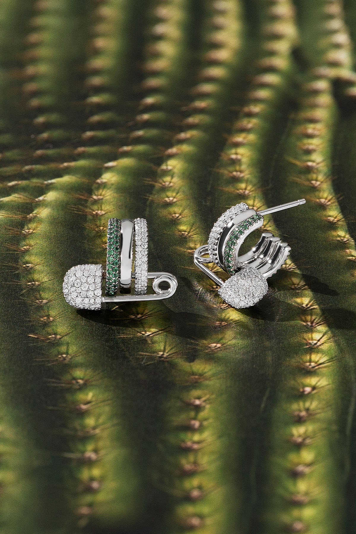 Silver earrings with green stones on a cactus background