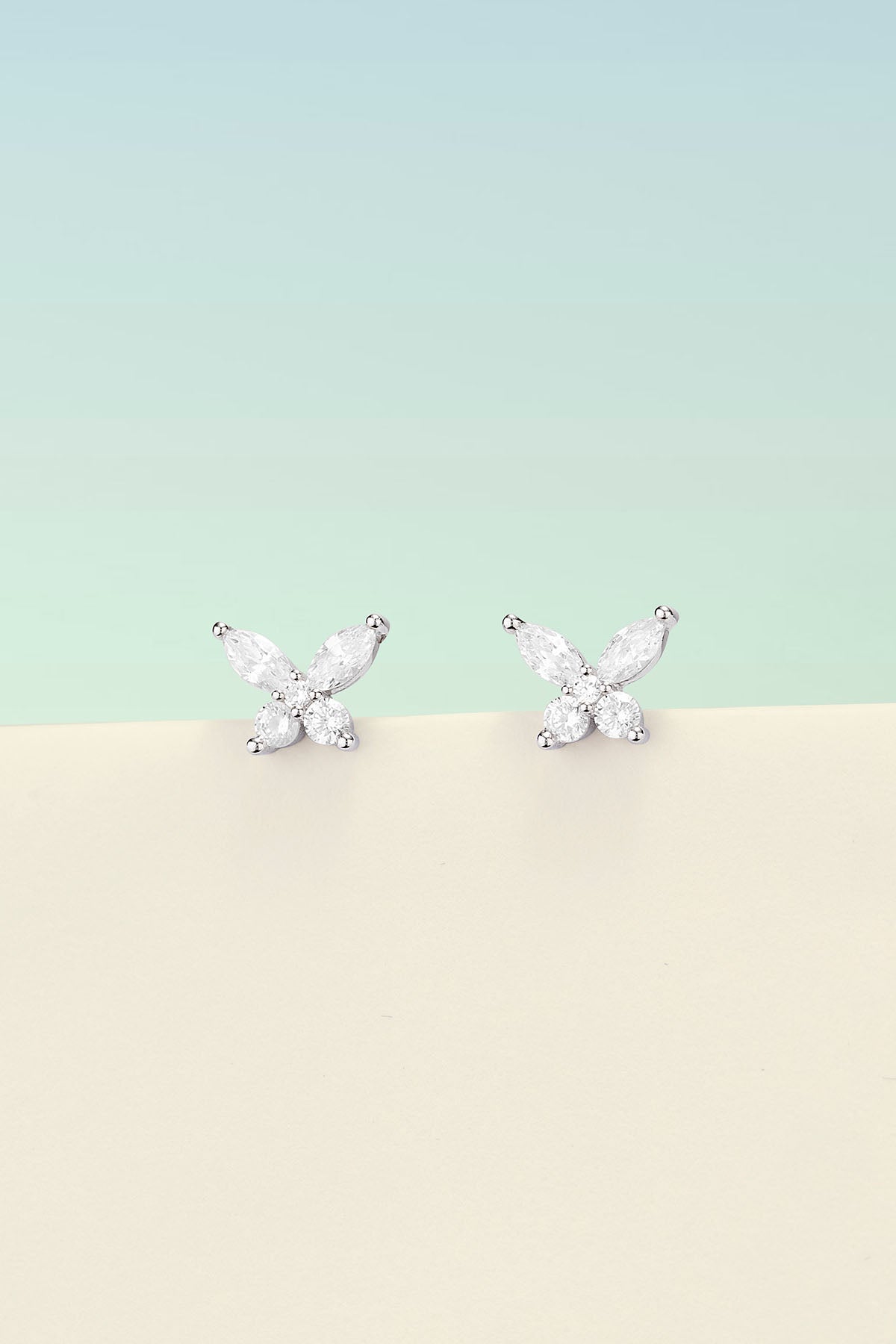 Earrings, APM Monaco, white butterfly-shaped stud earrings in silver-tone metal.