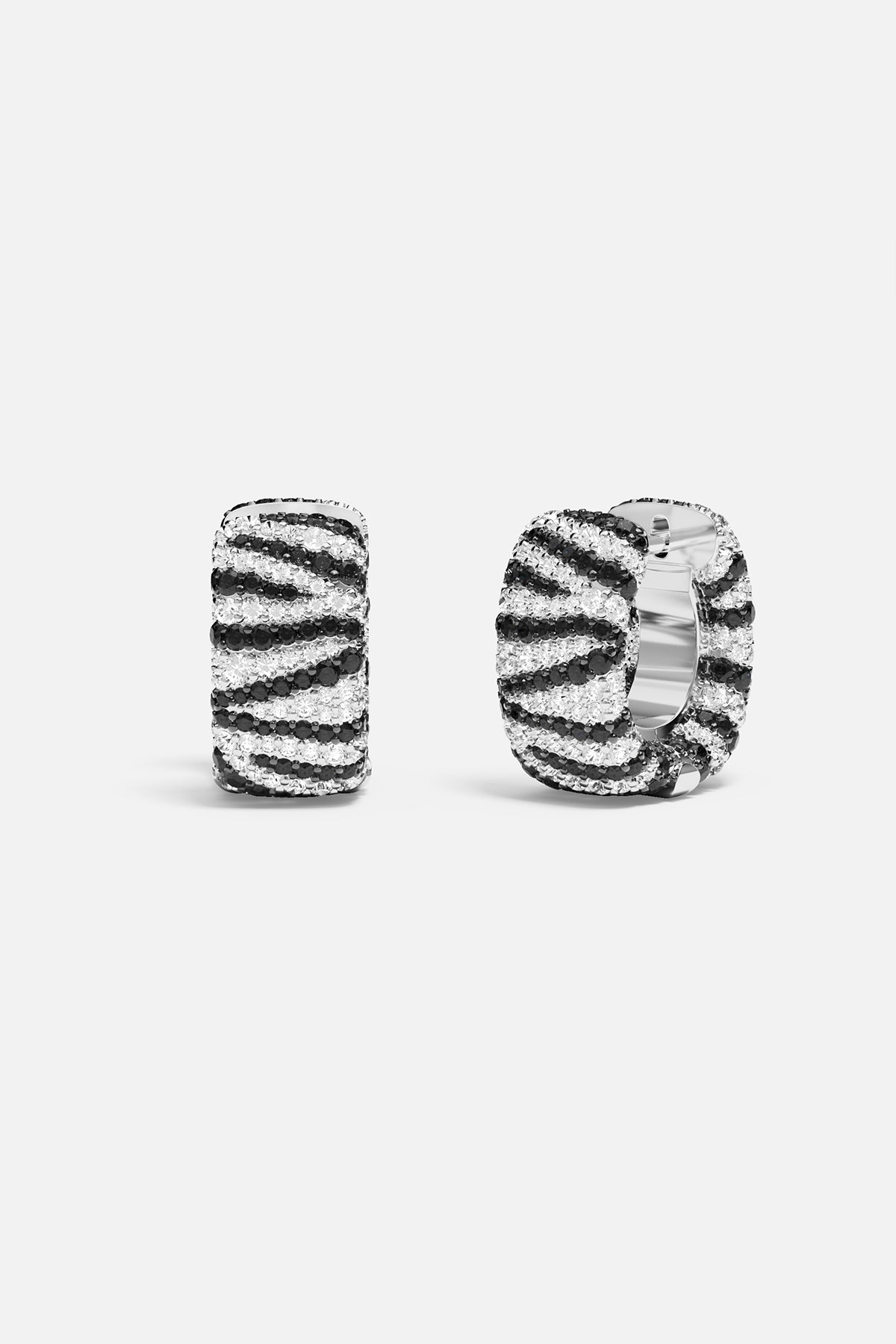 Earrings APM Monaco zebra-striped hoop earrings in black and white.