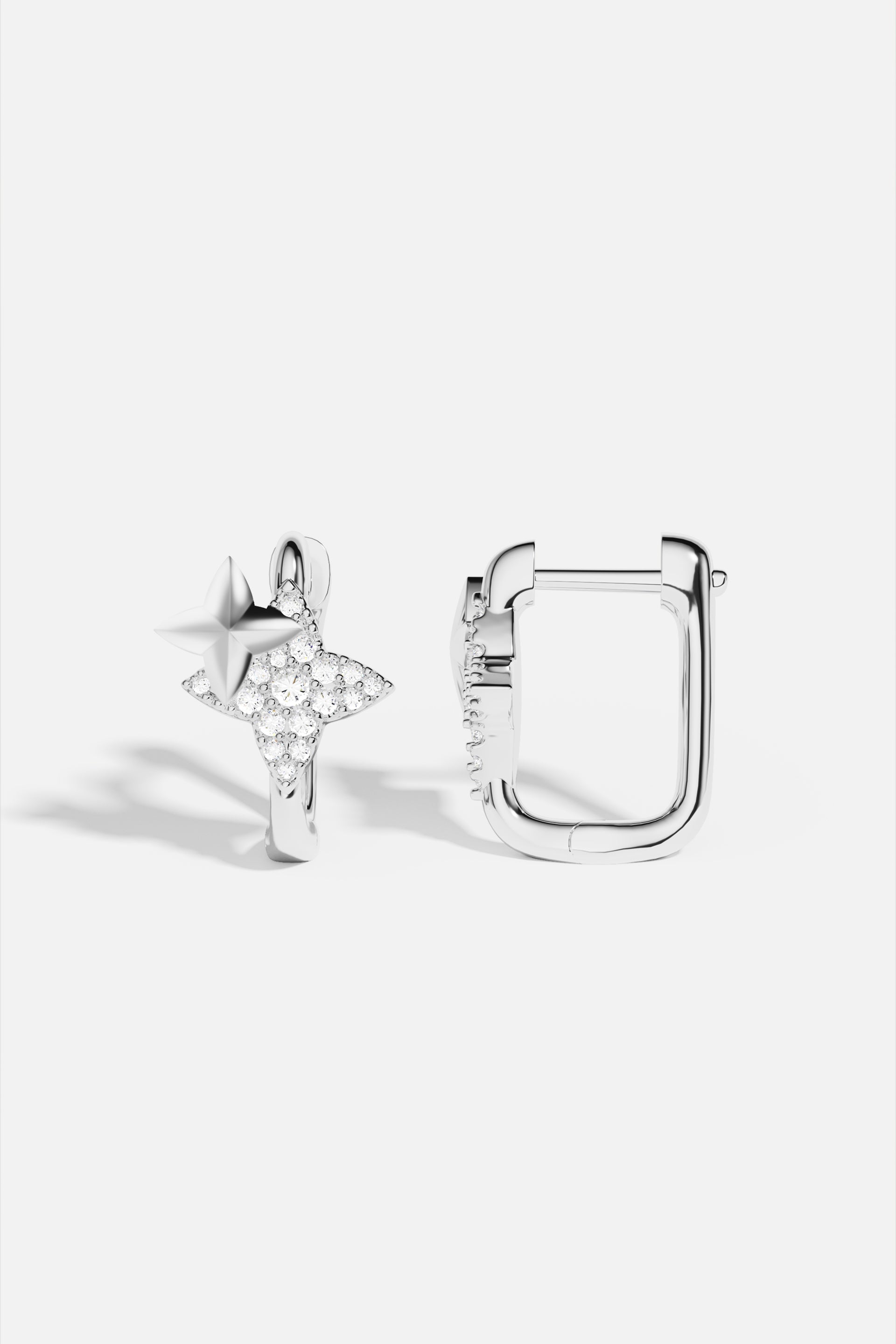 Earrings APM Monaco - silver-tone studs featuring a pavé crystal star and a square crystal design.
