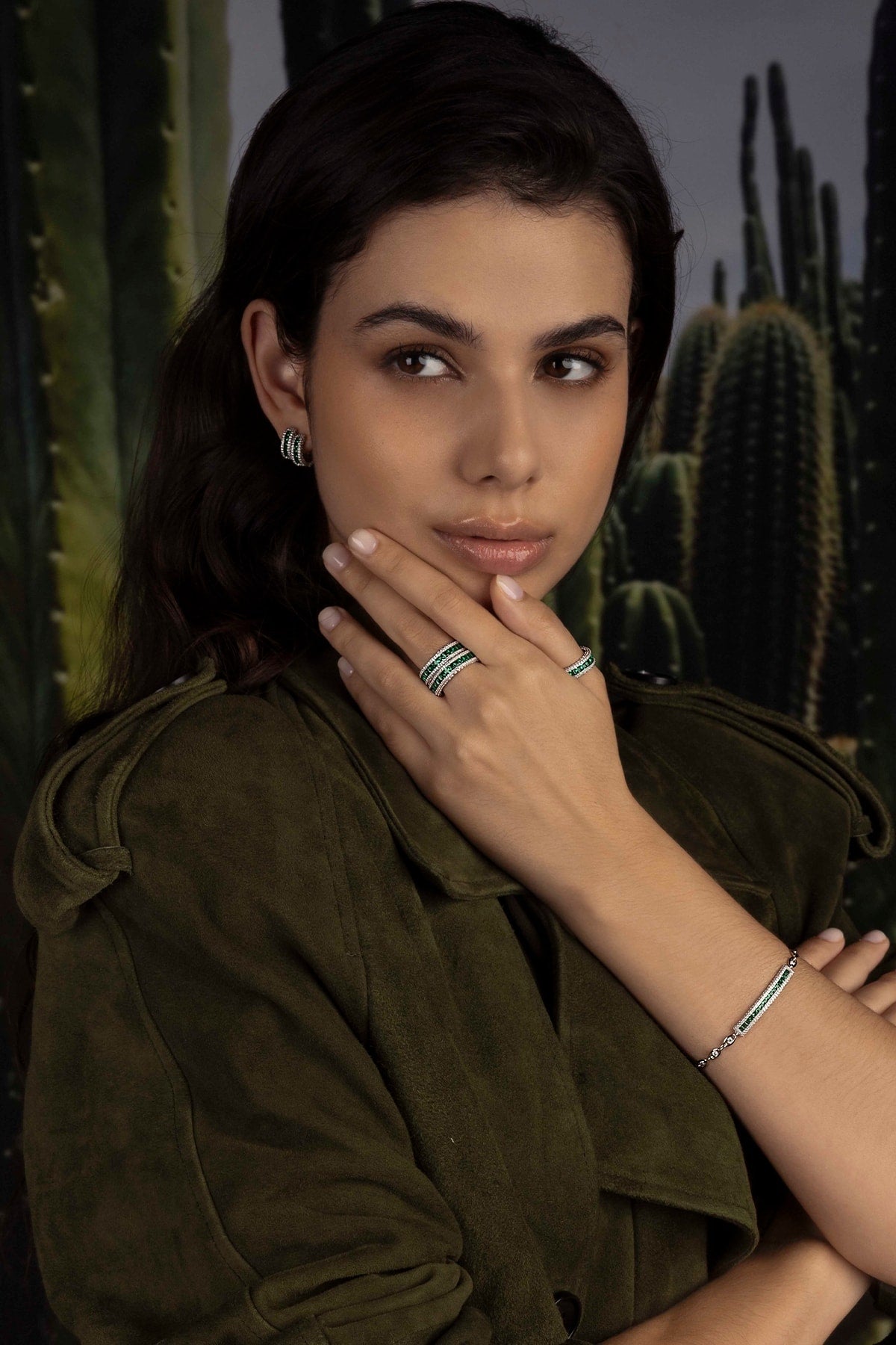 Model with jewelry against a cactus background
