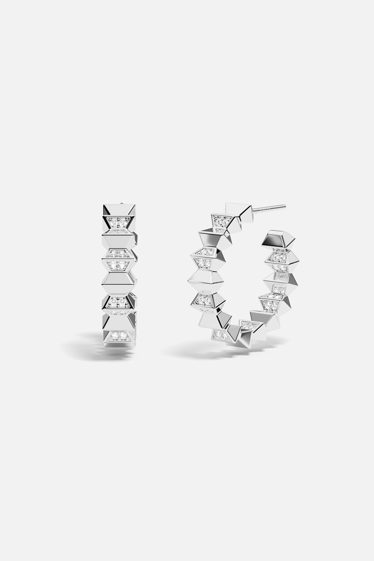 Pair of silver hoop earrings with geometric design on a white background