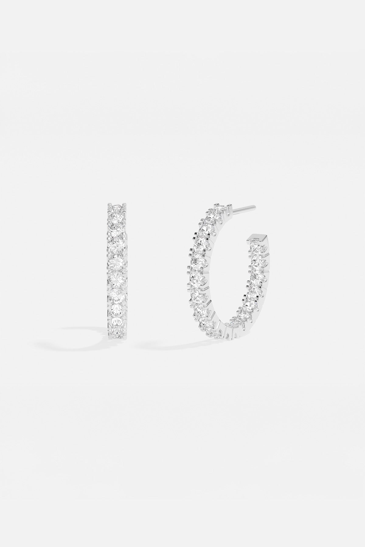 Earrings APM Monaco hoop earrings in white silver-tone metal with clear stones.