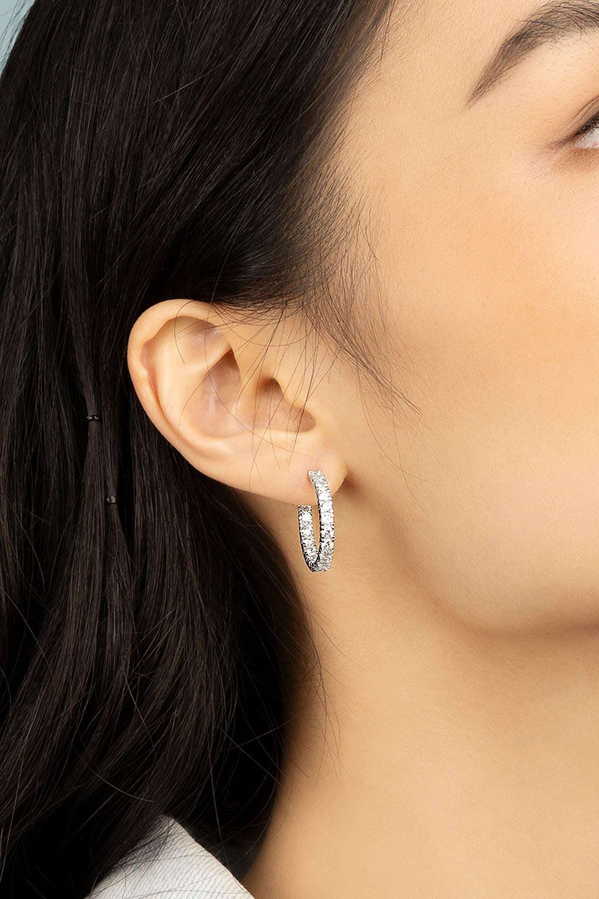 Earrings APM Monaco – white pavé hoop earrings with small crystals.