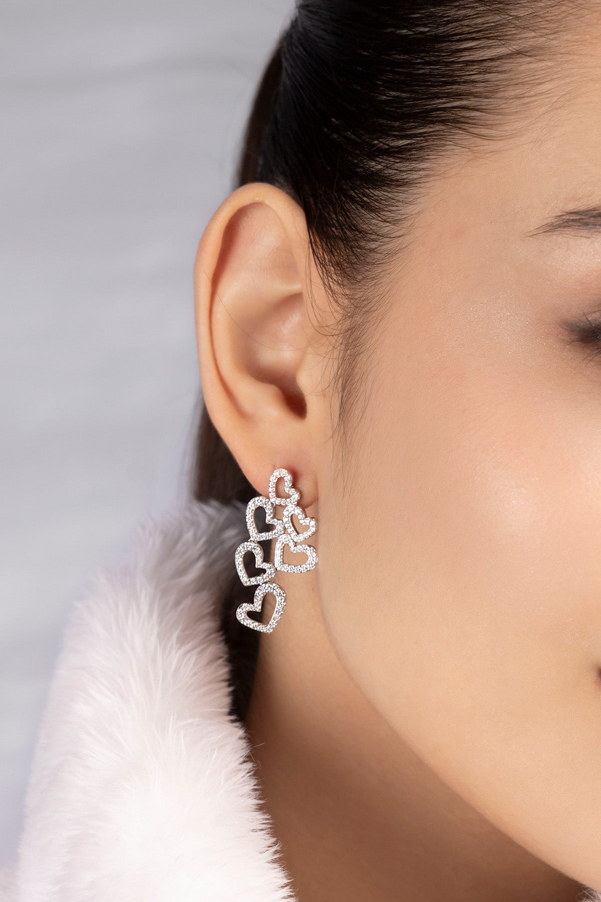 APM MONACO heart-shaped earrings worn on model
