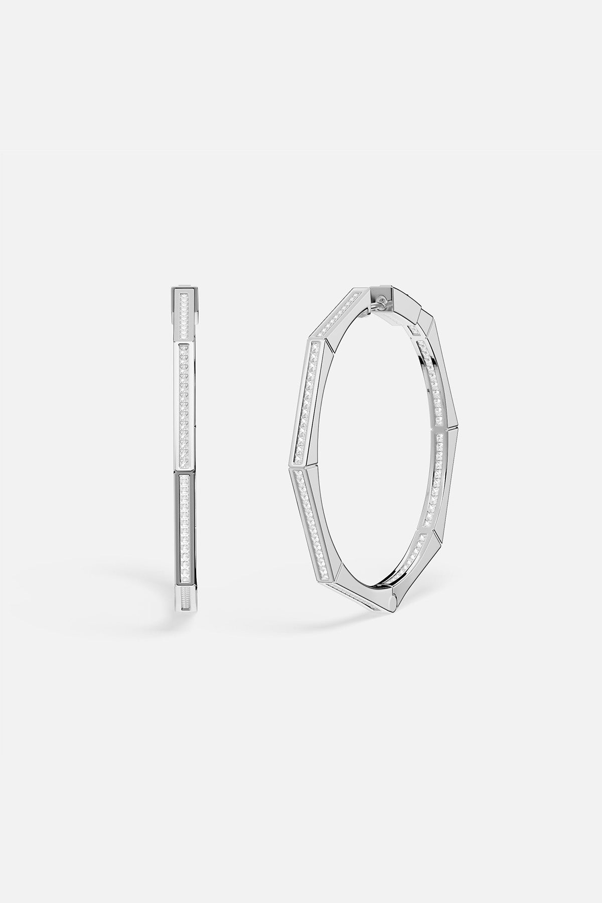 Pair of APM MONACO silver hoop earrings on a white background