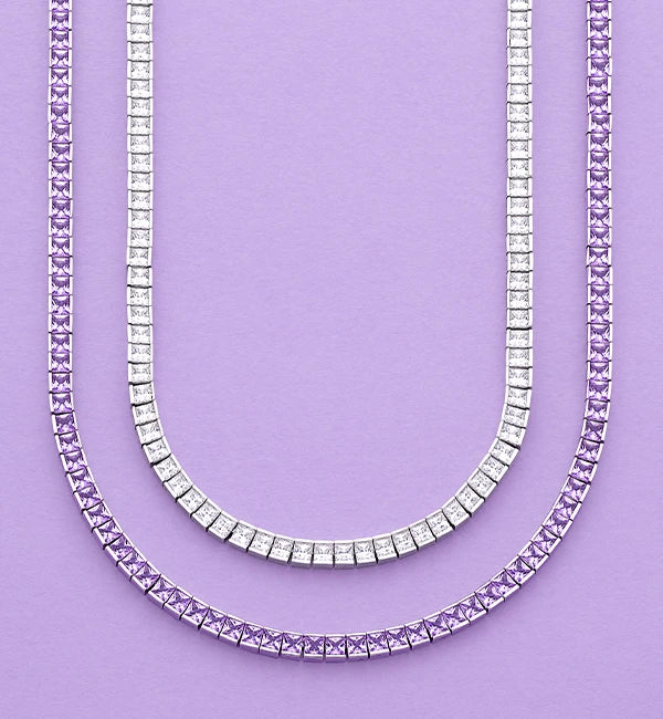 Two APM MONACO Lumière Pavé Chokers in purple and white on purple background