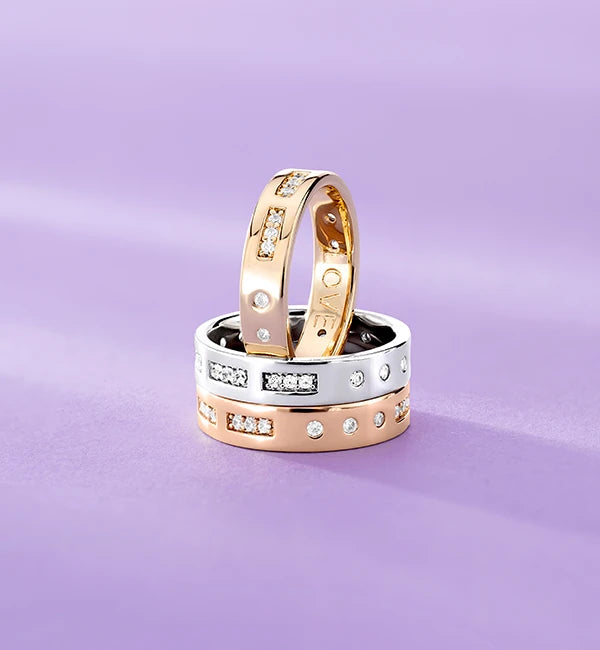Three APM MONACO morse code rings on a purple background
