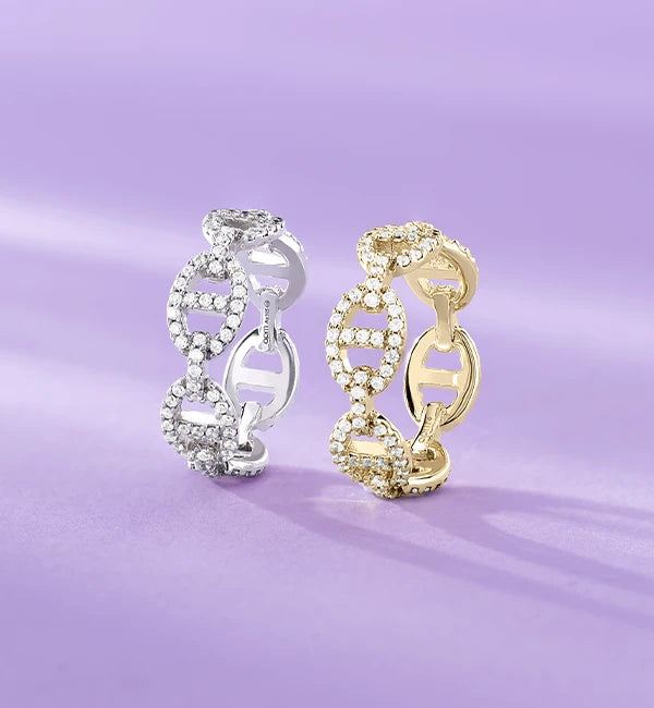 APM MONACO yellow gold and silver hoop rings from yacht club collection on a purple background