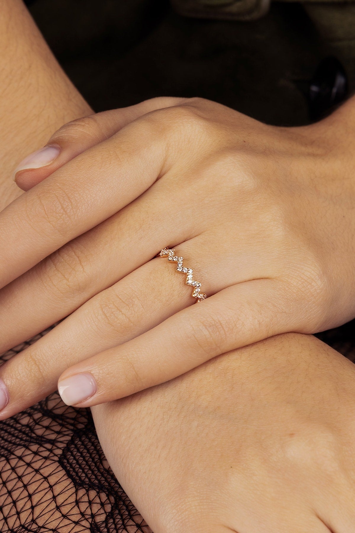 Close-up of a hand wearing a ring with a blurred background